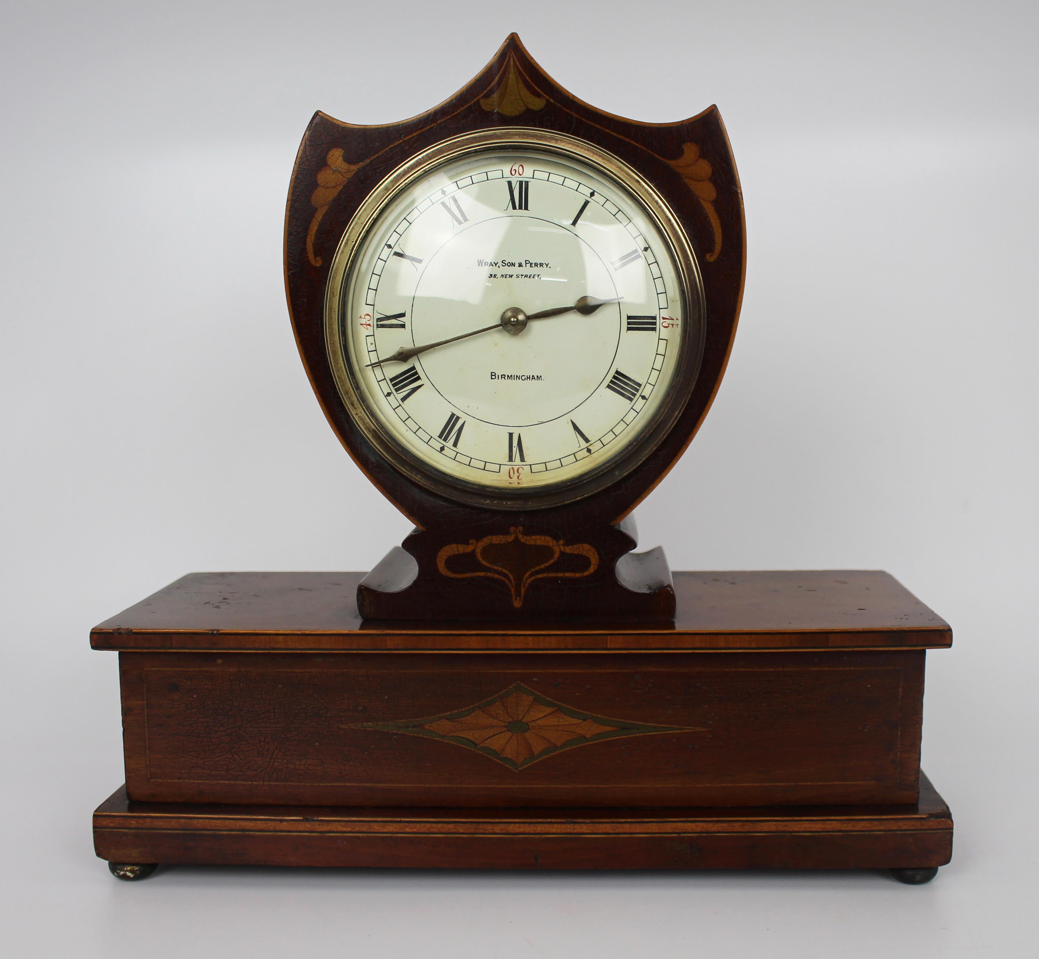 Elegant inlaid mahogany mantle clock by Wray, Son & Perry c.1900


Fine small antique Victorian mantle clock 

Wray, Son & Perry 38 New Street, Birmingham. 

Mahogany clock with satinwood & ebony inlay. 

The upper clock of shield form,