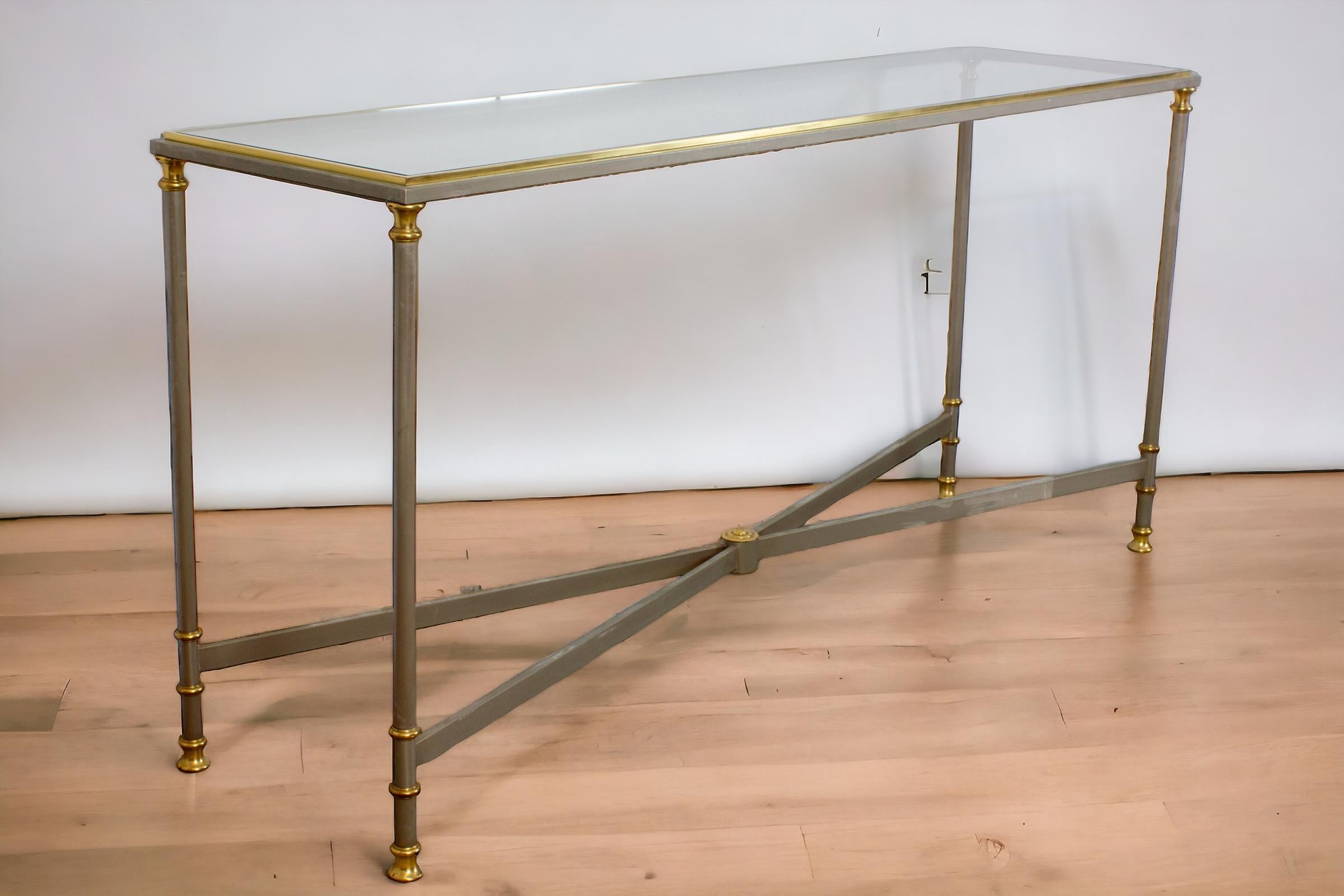 Elegant Italian Midcentury  Iron console table with brass legs and decoration. 
Glass top. Excellent vintage condition .
 Craftmade design by Orlandi the worldwide famous Italian forging iron company .
 This model was designed for the interior