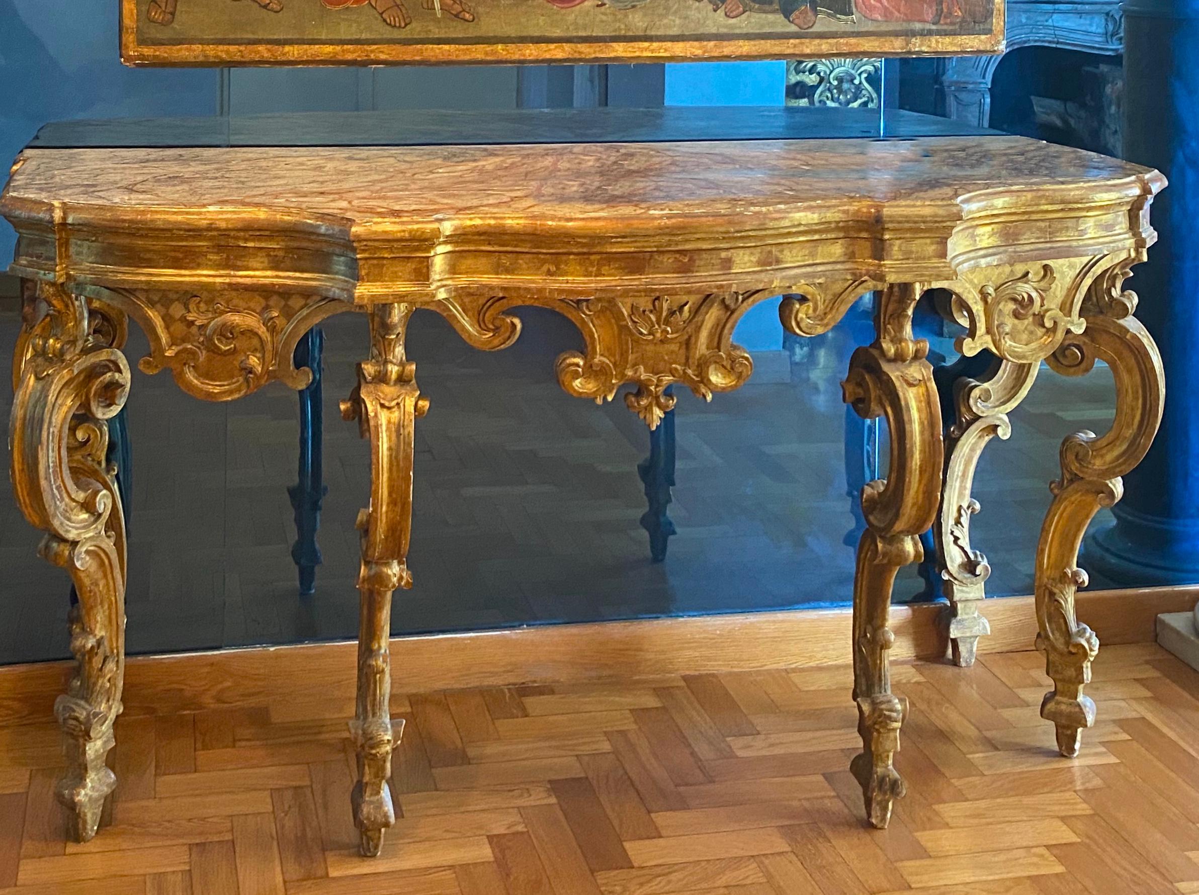 Elegant Nord Italian 18th century carved and giltwood console table with a painted faux marble top.
The table with original gilding will be fully restored before delivery.
Provenience: Leo Veneziani Collection.
Size: cm 175 x 65 x 93.