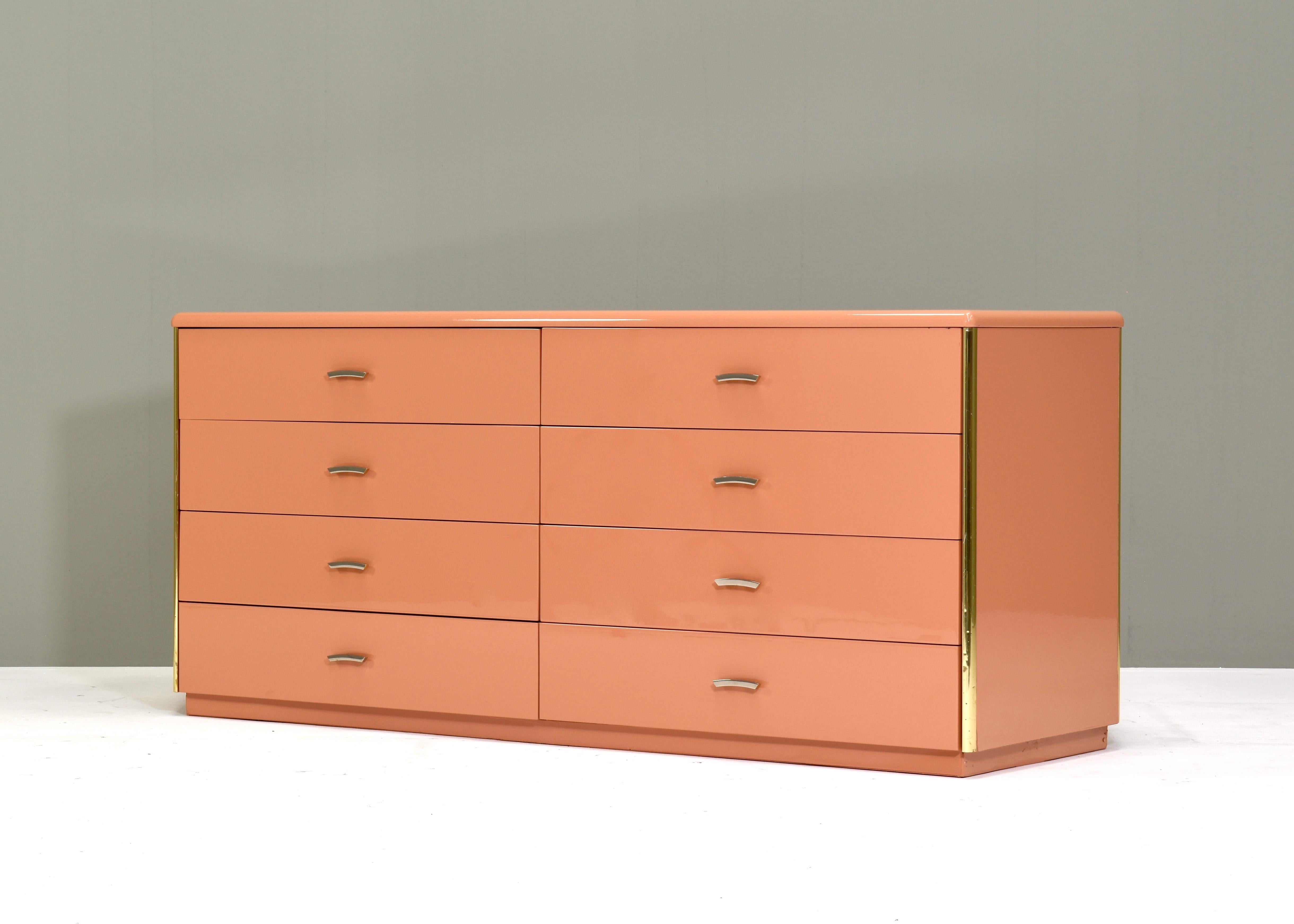 Designer: unknown

Amazing sideboard / credenza with eight drawers and brass details. The sideboard has been professionally repainted by the previous owners in a Flamingo pink high gloss lacquer.
Italy – circa 1970

Manufacturer: Unknown
Size