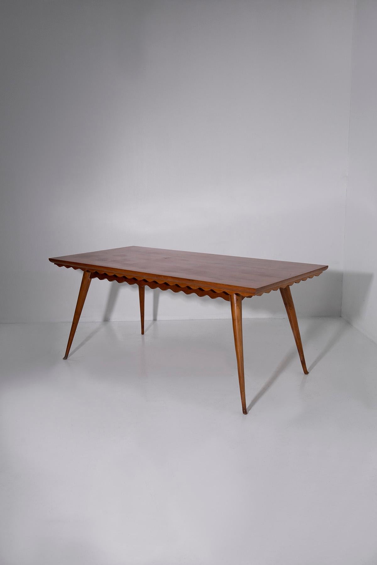 Step into the timeless elegance of mid-century Italian design with this exquisite dining table attributed to the masterful Paolo Buffa. Crafted in the 1950s, this table stands as a testament to the unparalleled craftsmanship and refined aesthetic of