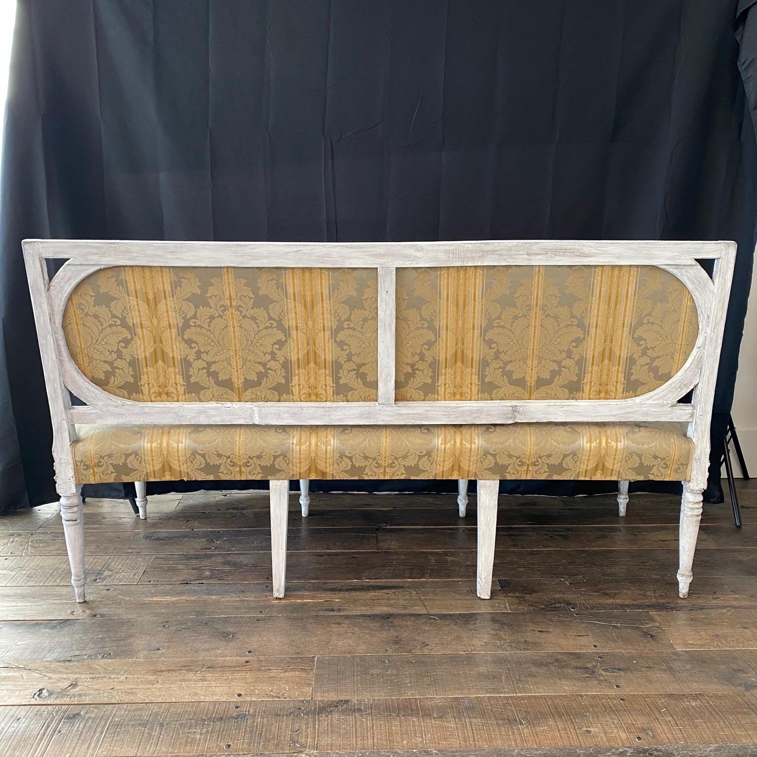 Elegant and classic 18th century authentic Italian Neoclassical sofa that's part of a salon set with two armchairs or fauteuils, selling separately.  Upholstered in a stunning neutral raw-silk with original paint. In wonderful shape for its age (a