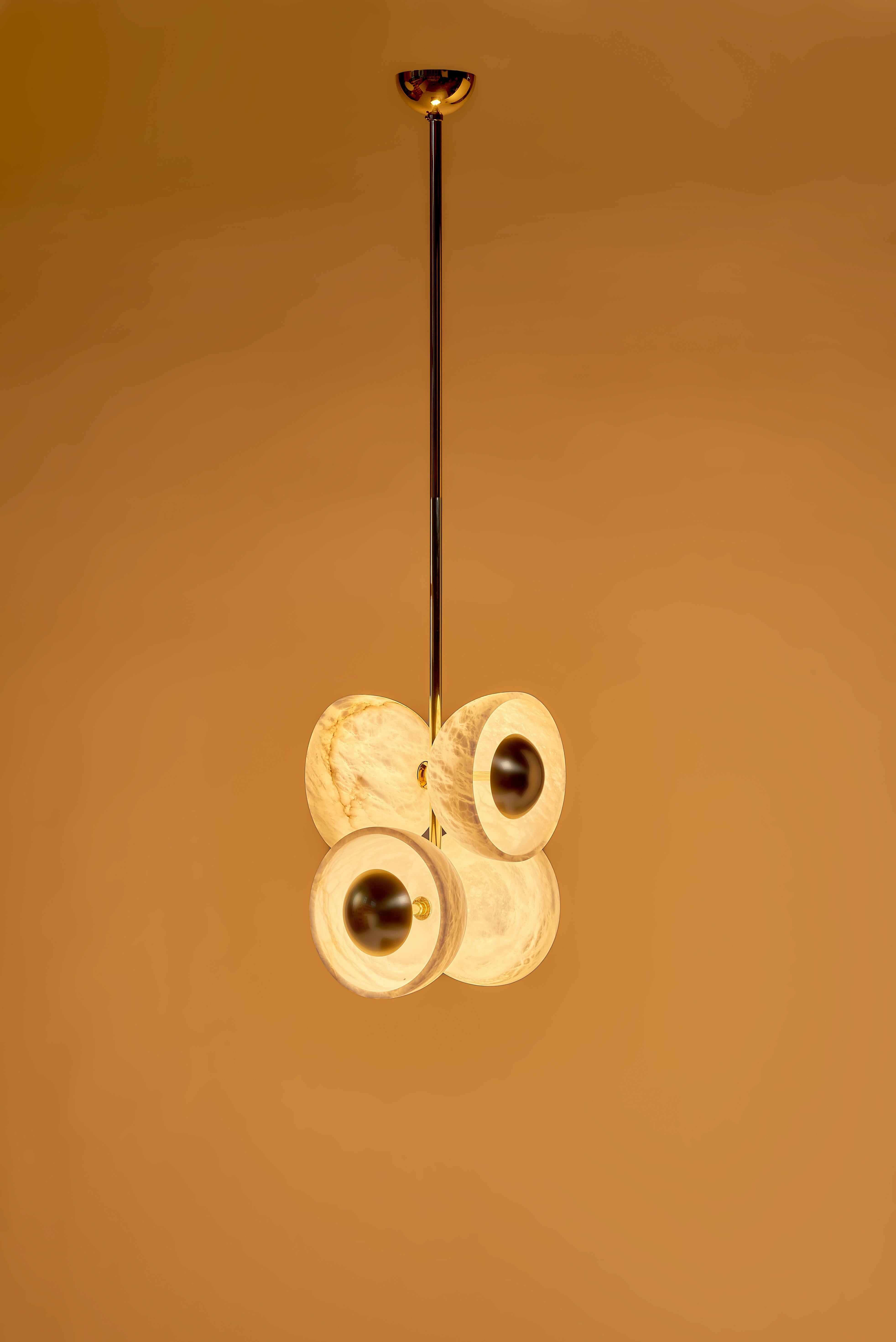 The Butterfly pendant is a captivating lighting fixture that combines elegance, compactness, and a touch of whimsy. Its design is inspired by the graceful wings of butterflies, which is reflected in the use of alabaster cups and polished brass