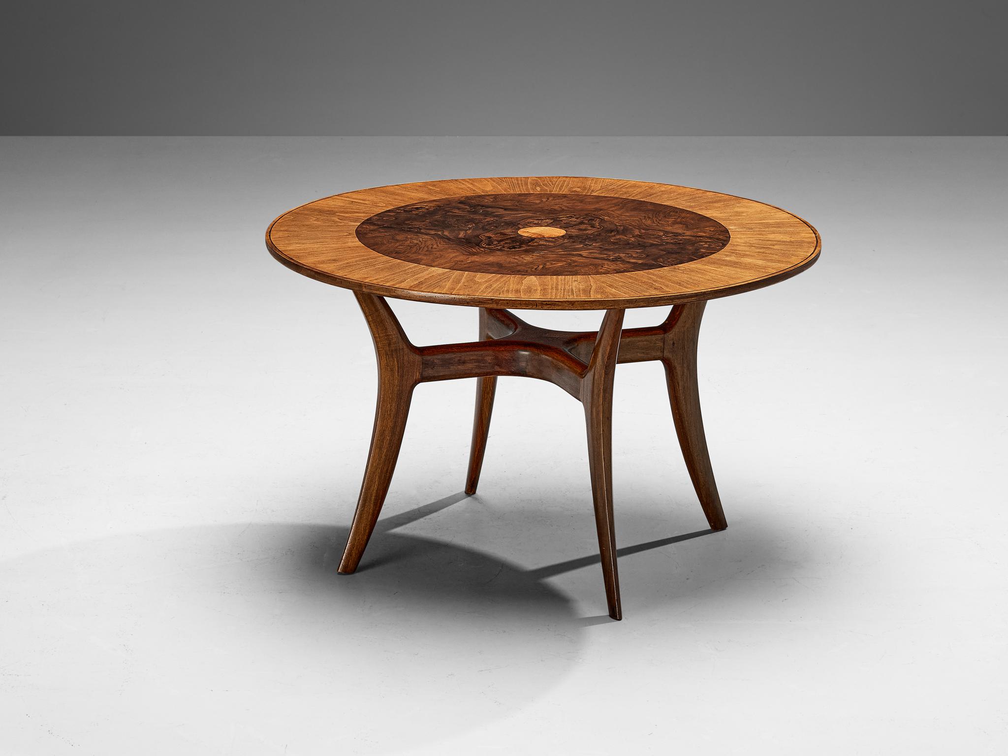 Dining or center table, briar, walnut, Italy, circa 1955

Stunningly elegant dining or center table made in Italy around 1955. This circular table shows an incredibly rich choice of materials, that elevate this design to great heights. The round top