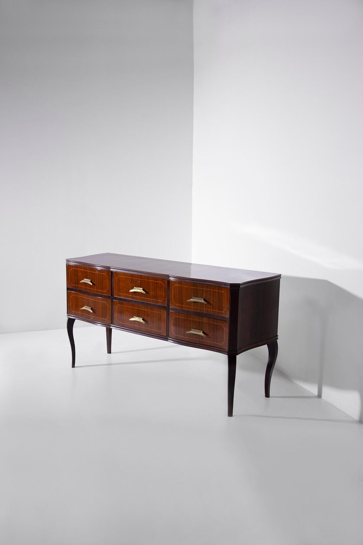 Step into the world of 1950s Italian design and discover an elegant vintage sideboard that effortlessly marries classic sophistication with modern functionality. This exquisite piece, crafted from a harmonious blend of brass and walnut wood, is a