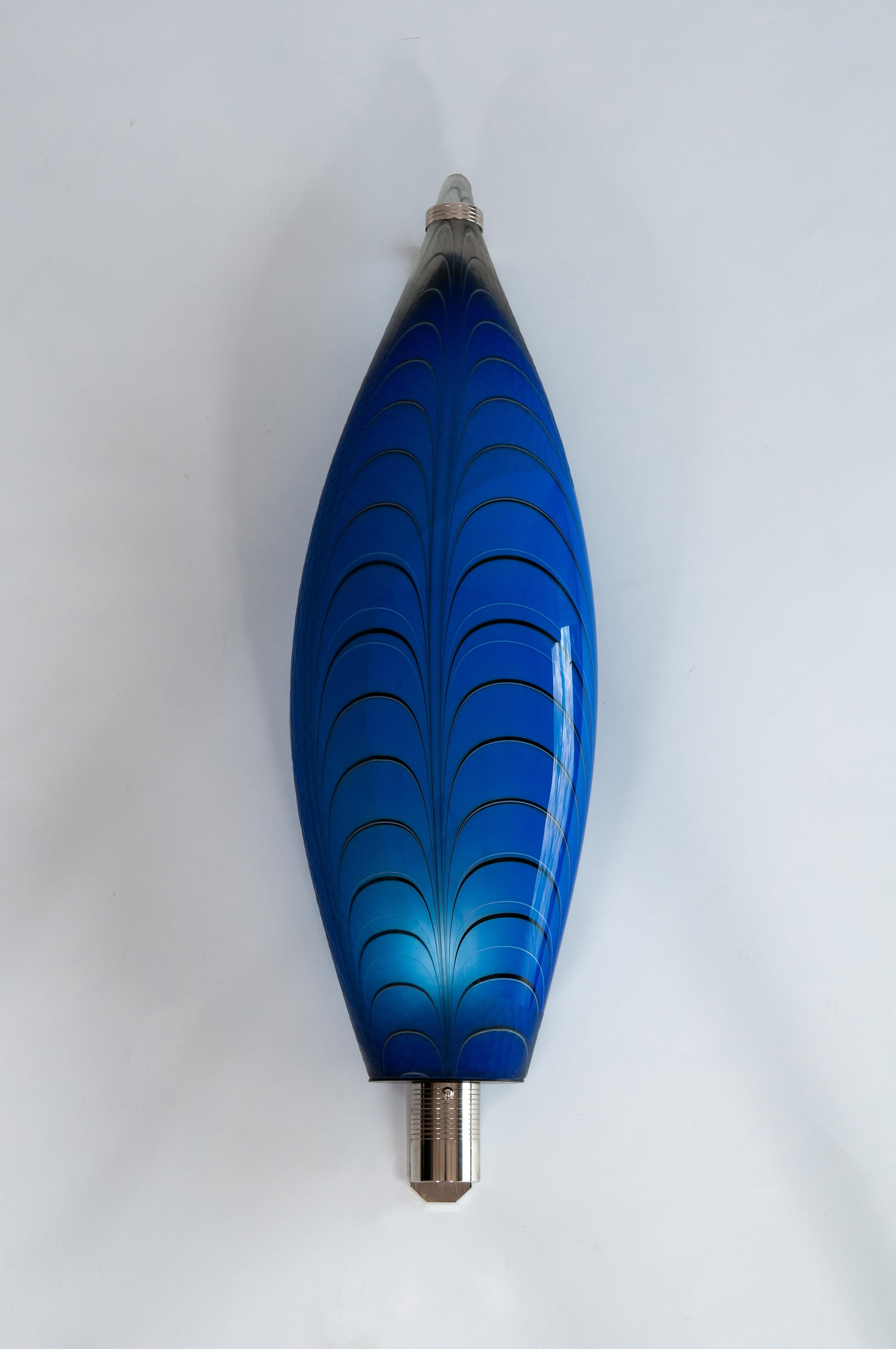 Murano Glass Wall Lamp Fish shaped Blue color hand carved  Contemporary Italy.
This lamp could either be used as a Table lamp or a sconce wall lamp. 
This magnificent wall lamp is entirely handmade in blown Murano glass. The main body is one glass