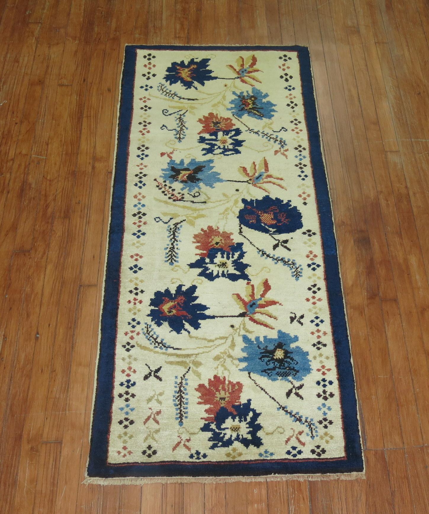 One of a kind vintage Turkish Konya runner from the mid-20th century. A floral design on a ivory field with large navy blue, blue, and apricot flowers surrounded by a thin sold navy border

Measures: 2'7'' x 6'2''.