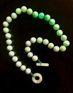Elegant jade beads w/ shade from mottled green to soft shades of green in back