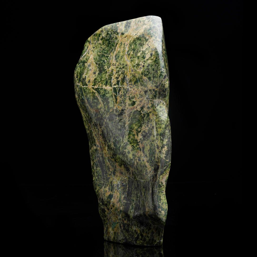 This striking jade freeform sculpture from Pakistan showcases the natural beauty of one of the world’s most treasured stones. Weighing heavily and carved in an organic, flowing shape, the piece highlights deep green hues with subtle variations that
