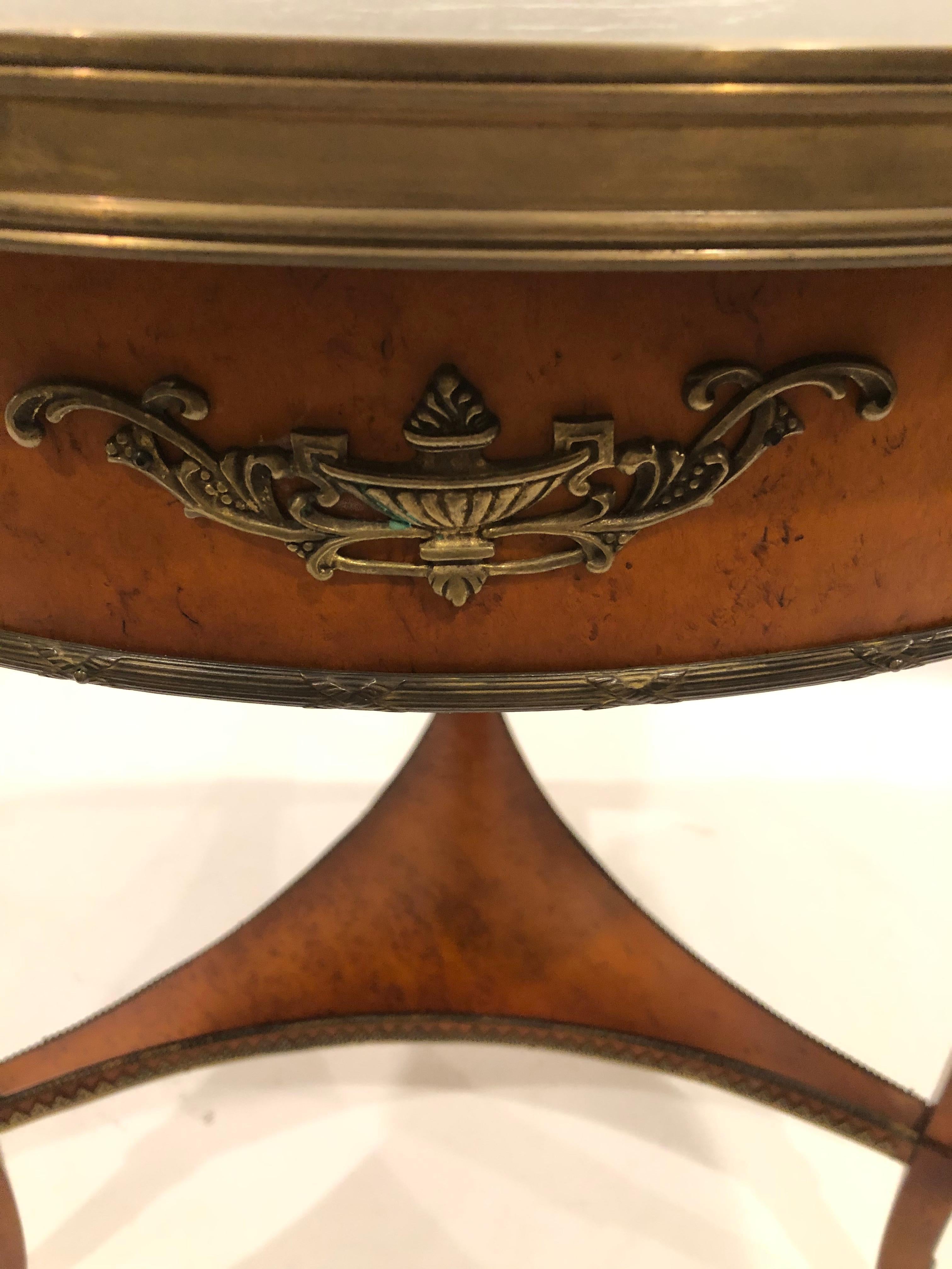 Superbly crafted elegant round side table having burl base with handsome bronze figural decoration at the top of each leg as well as other bronze flourishes and gallery around the periphery. The top is a gorgeous very dark green, almost black piece