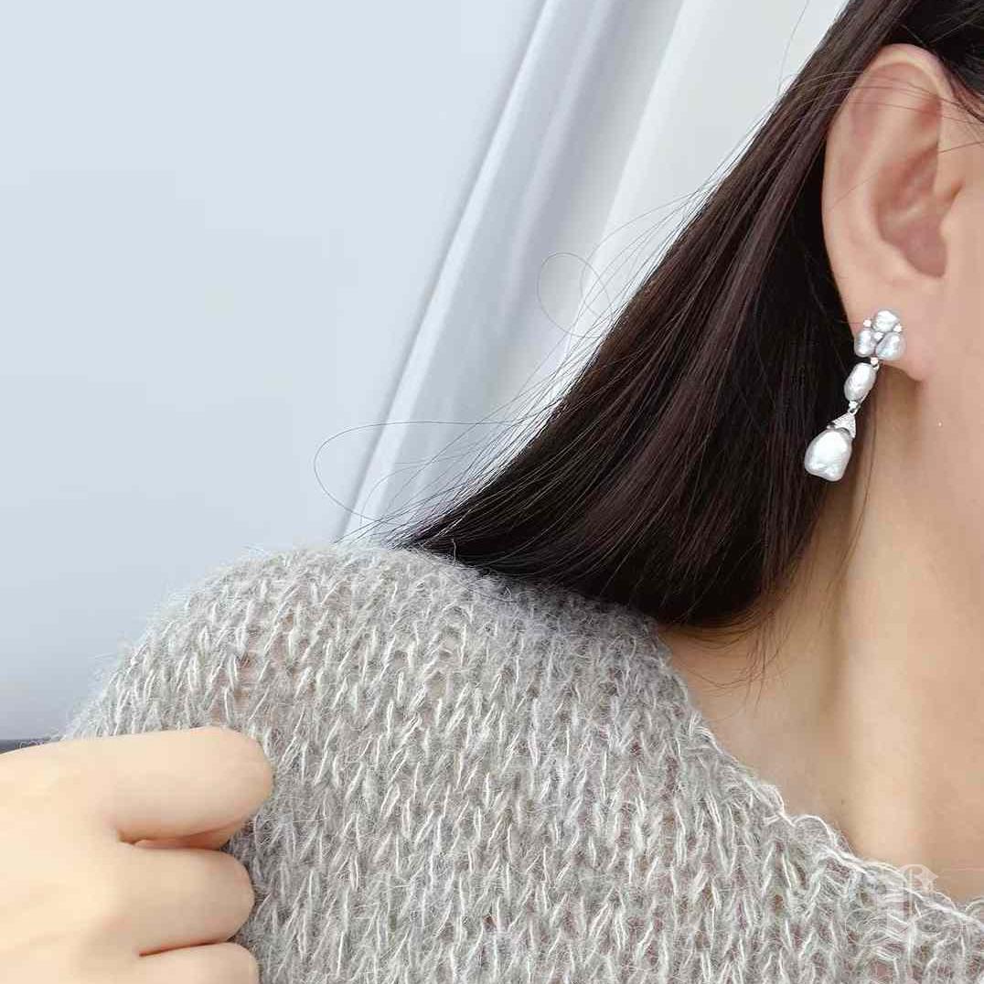 Crafted with luminous Keshi pearls, these exquisite earrings exude sophistication and natural beauty. Each pearl showcases its unique, organic shape, highlighting the individuality of this rare and highly sought-after material. The design is
