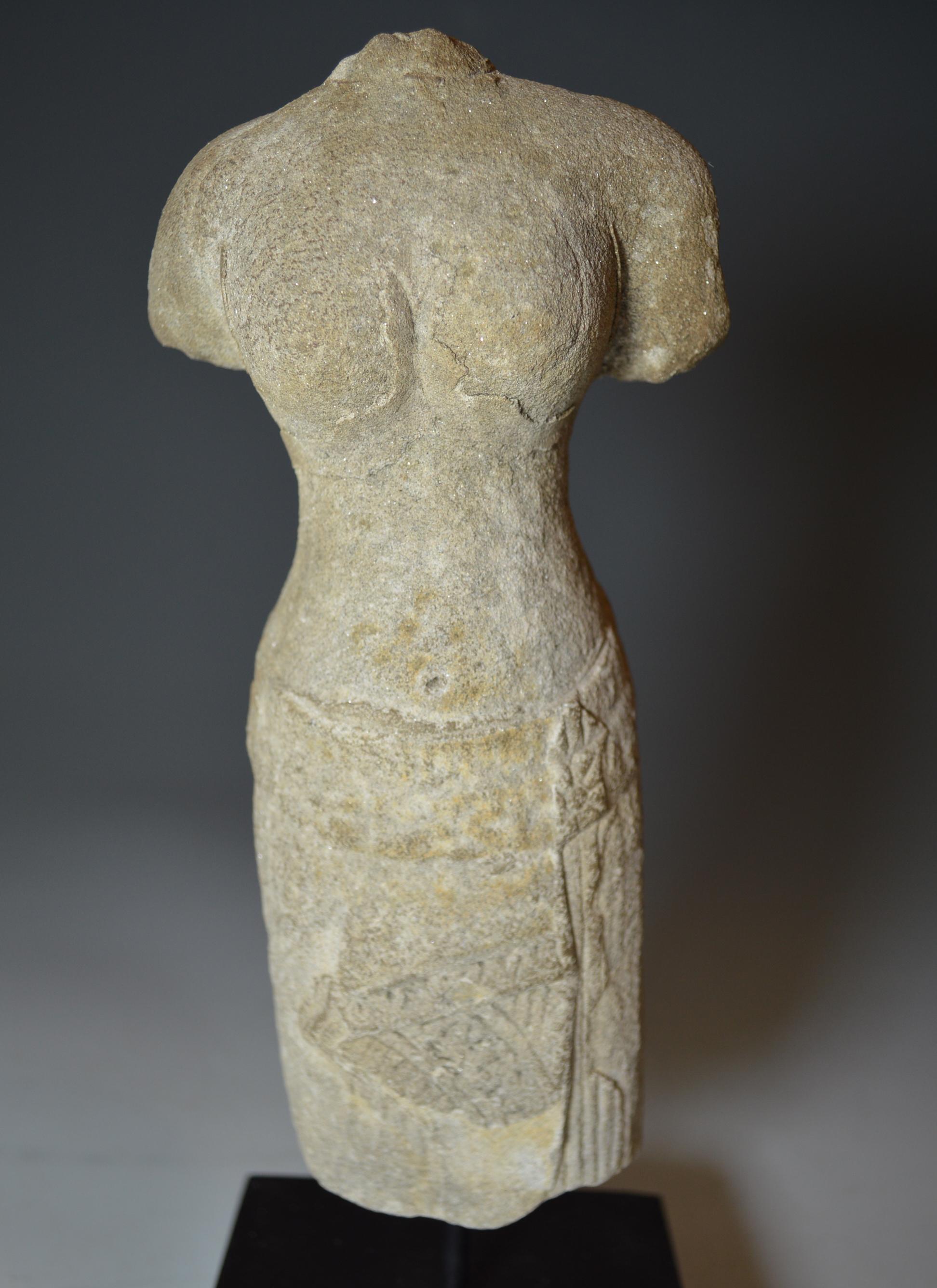 A elegant Khmer female standing figure with rounded shoulders and breasts in Samapada position wearing pleated sarong This is a Angkor Period figure depicting the goddess Uma (Parvati), the consort of Shiva and Hindu goddess of fertility, in the