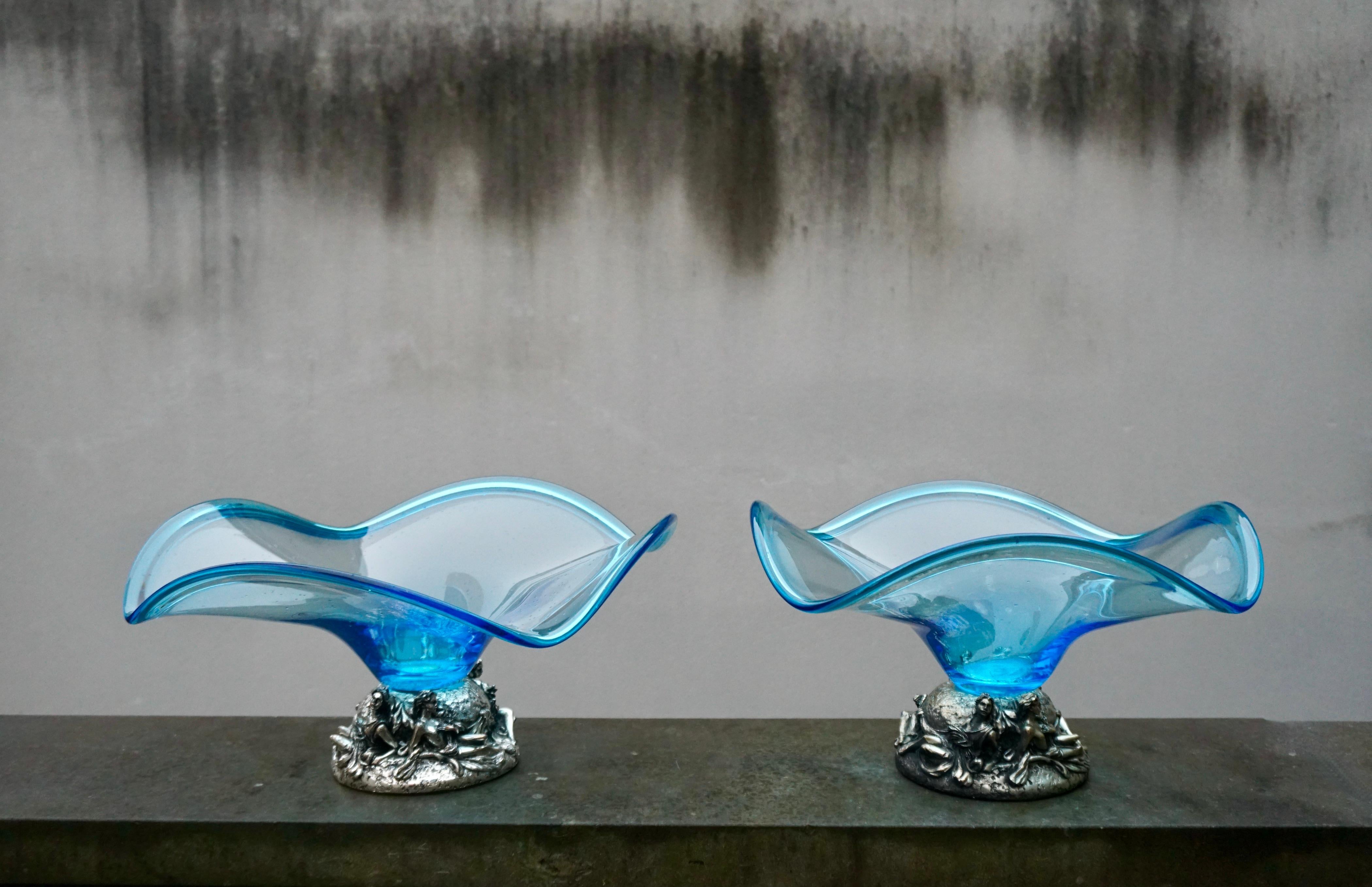 Pair of gorgeous rare Italian art glass bowl on a silver plated pedestal with the image of four woman. 

The bowl itself is made from blue, opalescent glass with a twist to it. The piece is in great condition. The silver base shines and the glass is