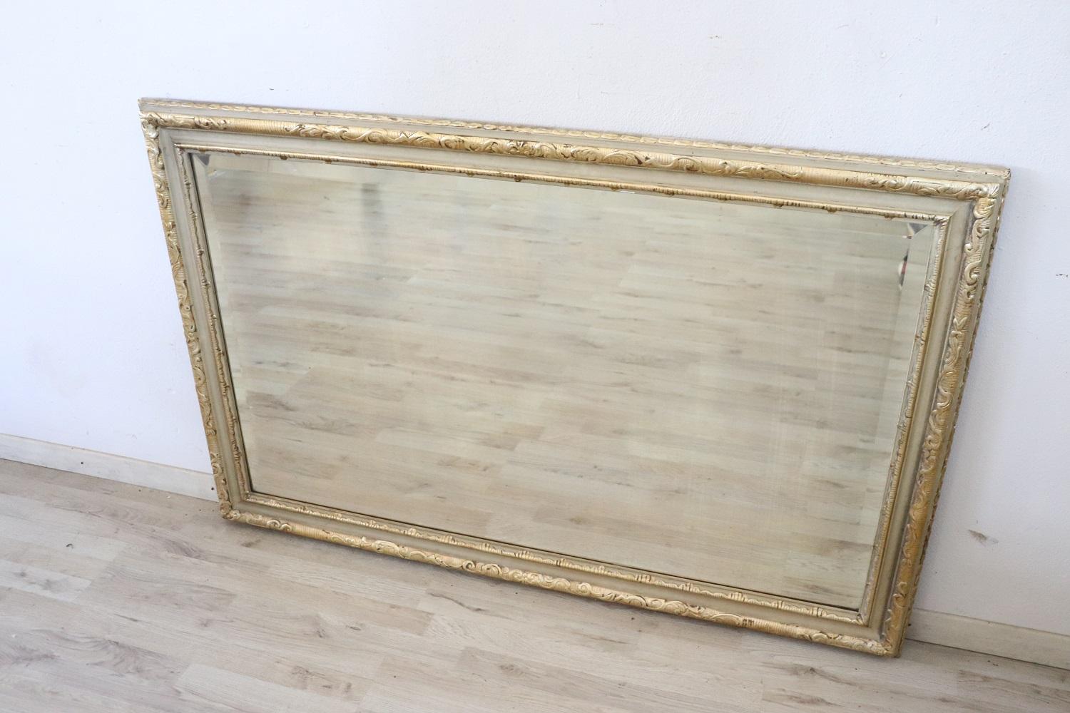 Elegant antique style wall mirror in lacquered and gilded wood.