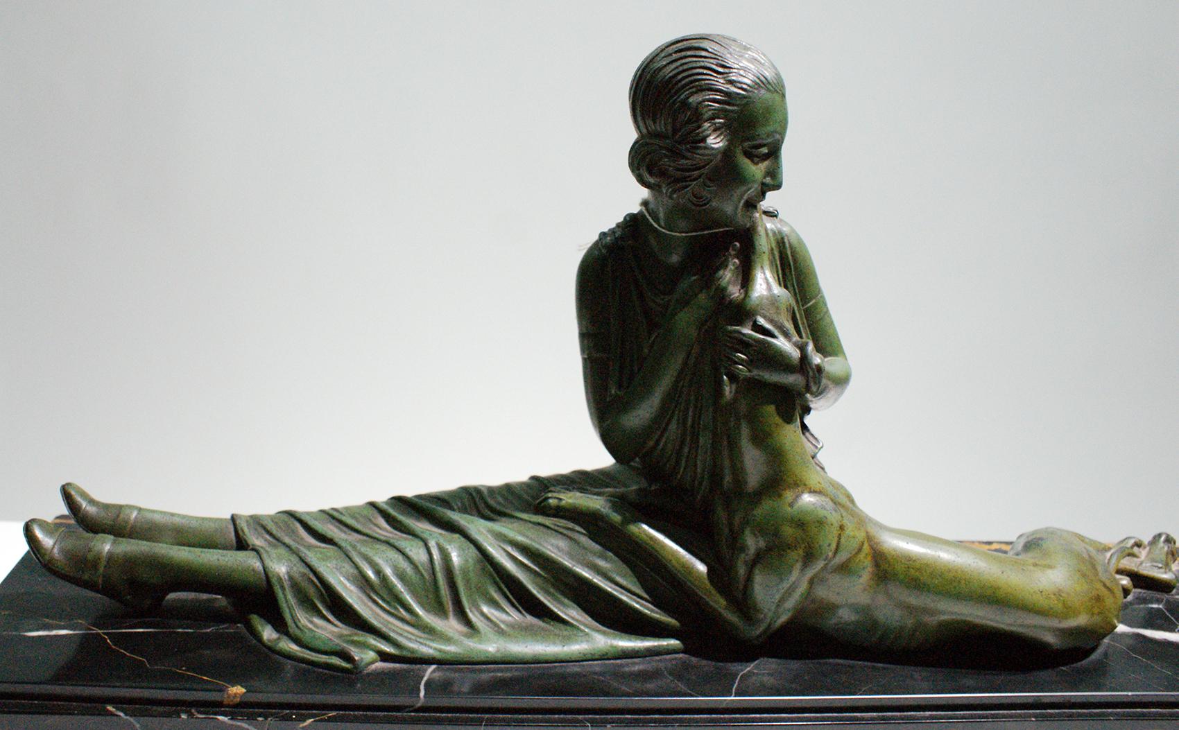 Very beautiful Art Deco sculpture depicting a sitting woman petting her greyhound. It is constituted of a bronze patinated green color mounted on a beautiful Portoro marble (5 cm of thickness) with the signature of the famous sculptor D.H CHIPARUS