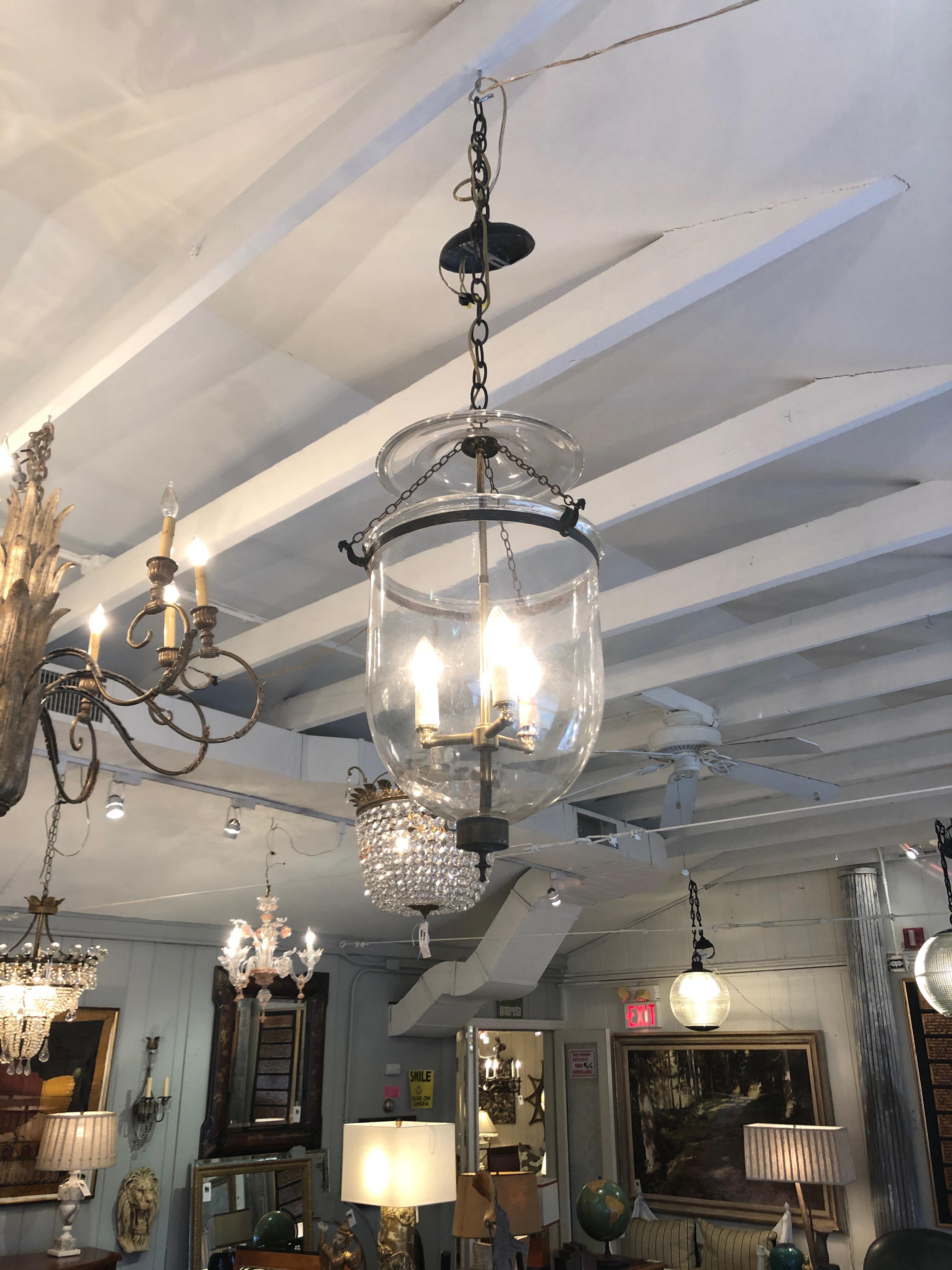 Beautiful glass and brass traditional lantern having 3 candle lights, brass with an aged unshiny patina, and 3 ft. of chain. Perfect for a stately foyer or hallway.