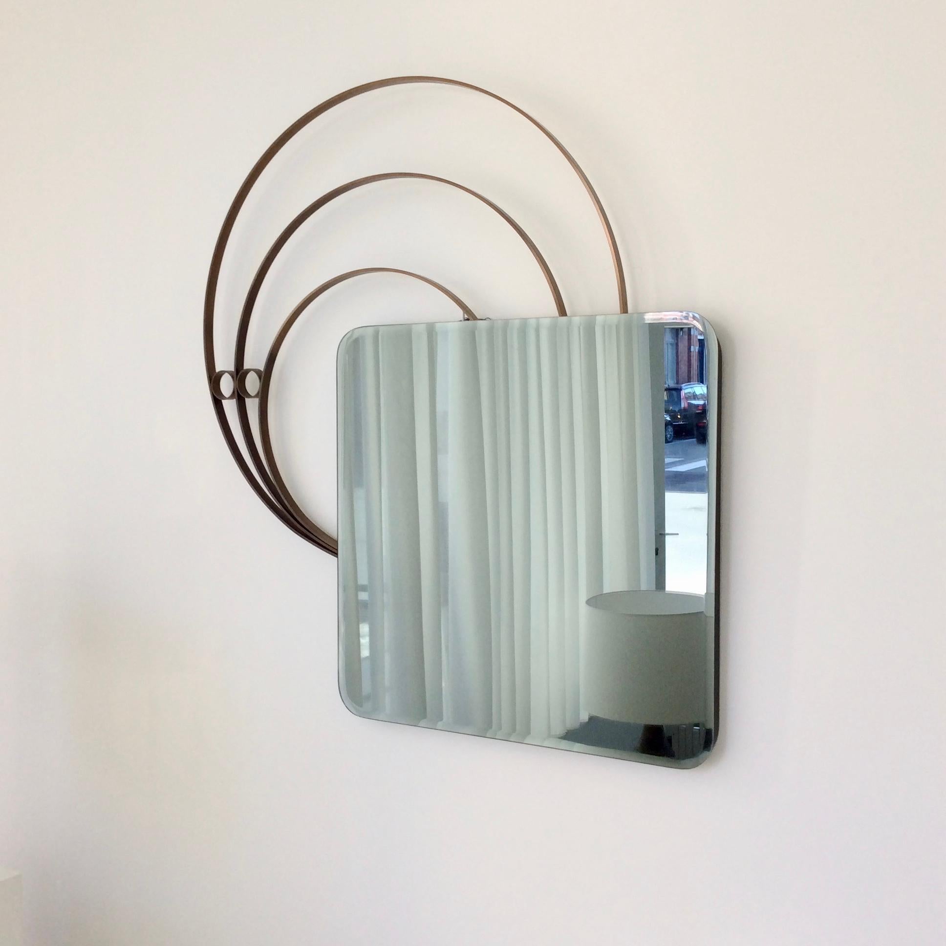Large decorative wall mirror, circa 1970, Fridgerio design attr. , Italy.
Grey tinted square beveled mirror, 3 patinated brass circles.
Dimensions: 99 cm H, 89 cm W, 4 cm D, mirror only: 62 x 62 cm.
Good condition.
 All purchases are covered by our
