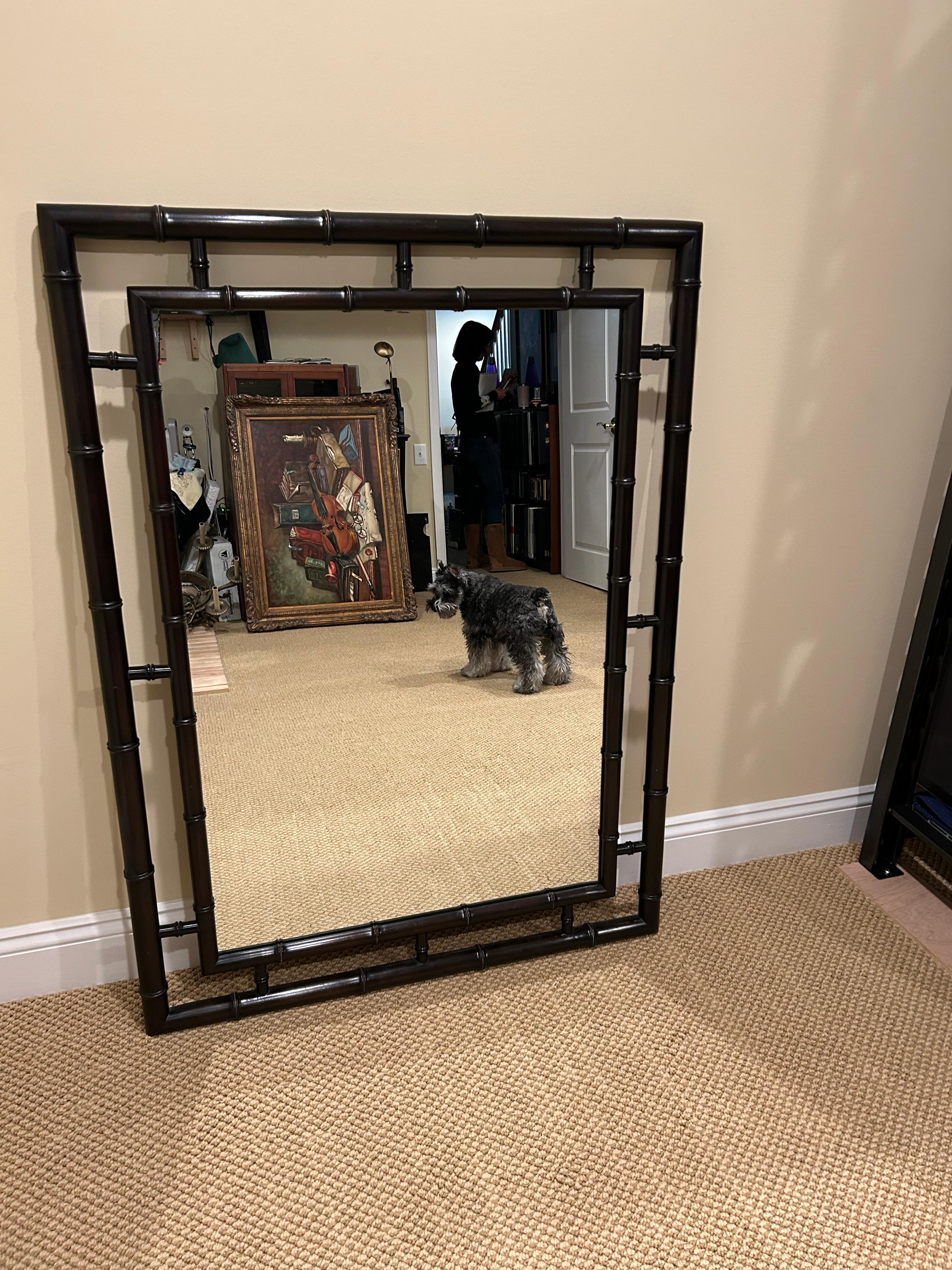 Miroir élégant et raffiné en bois foncé et faux bambou.
Le miroir lui-même mesure 25,5 l x 37,5 h.