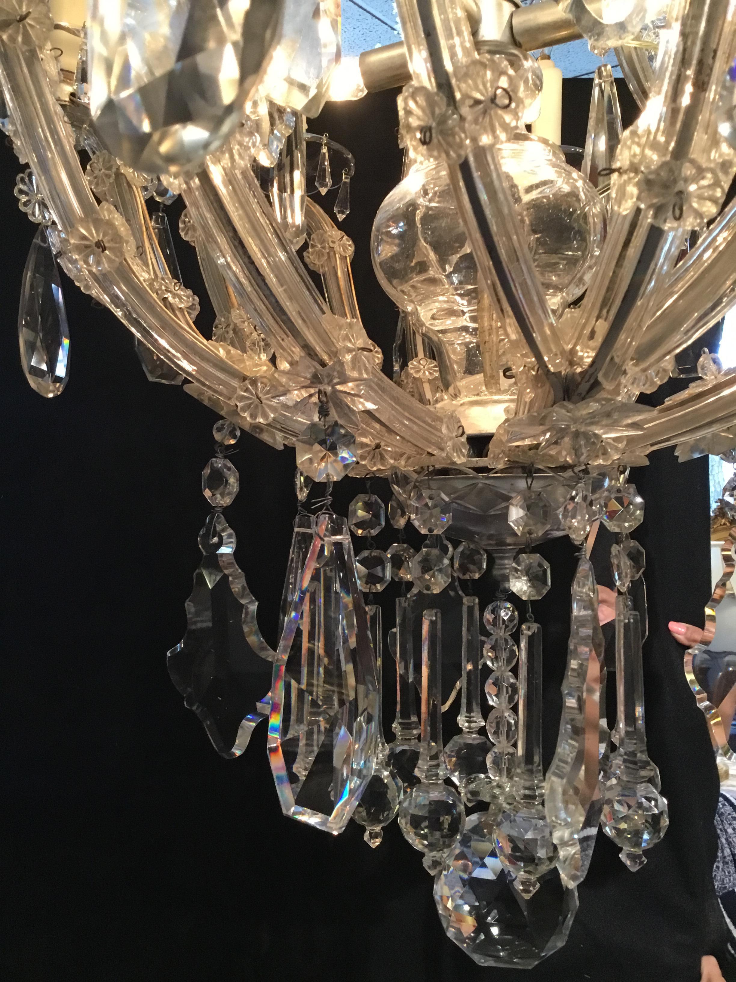 Italian Maria Teresa style antique fixture with exquisite crystals, having a silvered armature
which enhances the silvery and colorful glow of this piece. It has eight lights on the perimeter
and four-light inside the cage. It is in excellent