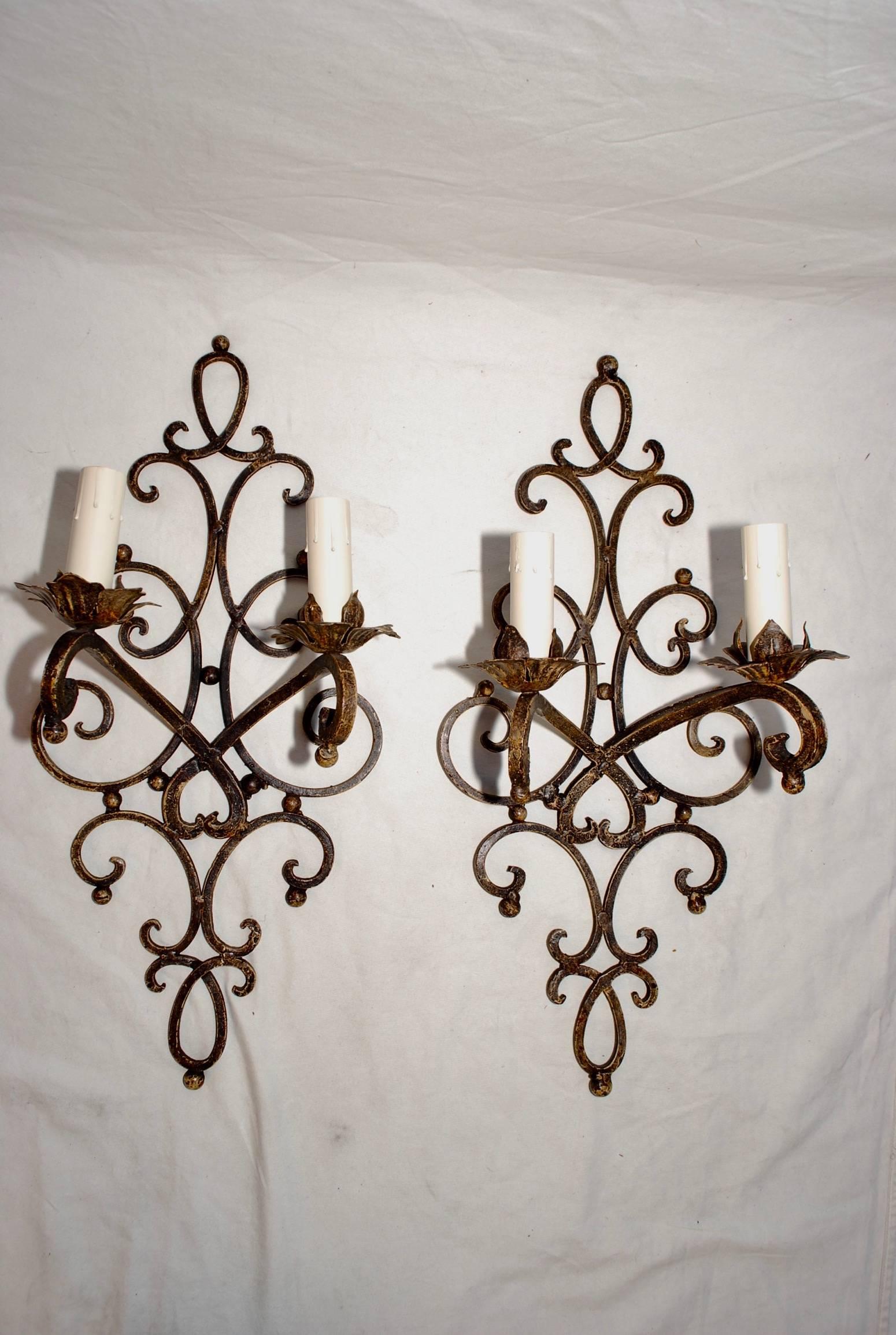 A beautiful pair of large French, 1940s iron sconces, the patina is much nicer in person.

     