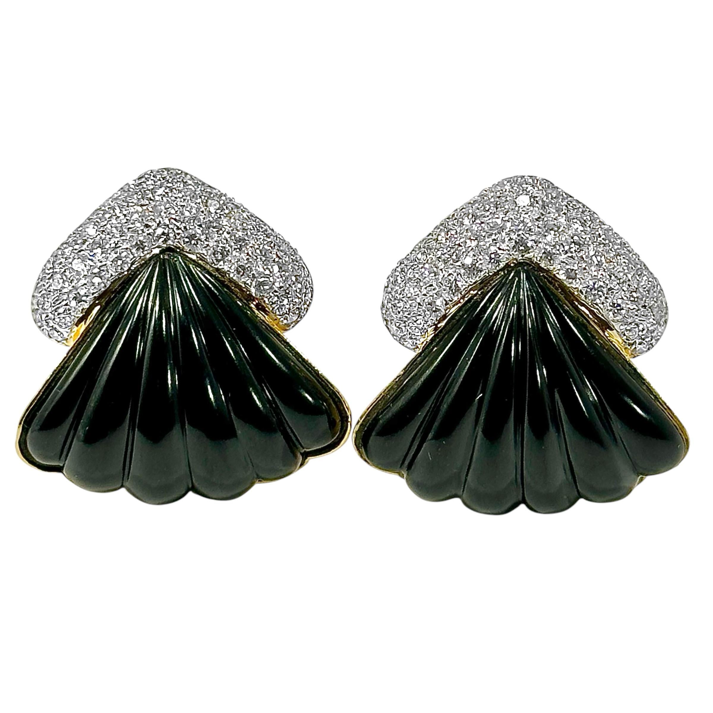 Crafted from rich 18K yellow gold, fluted black onyx panels and over 100 modern round brilliant cut diamonds, this very elegant pair of Late-20th Century fan motif earrings have a visual effect that is far greater than their physical scale. Each