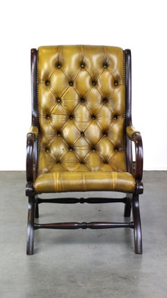 Elegant leather Chesterfield armchair combined with wood
