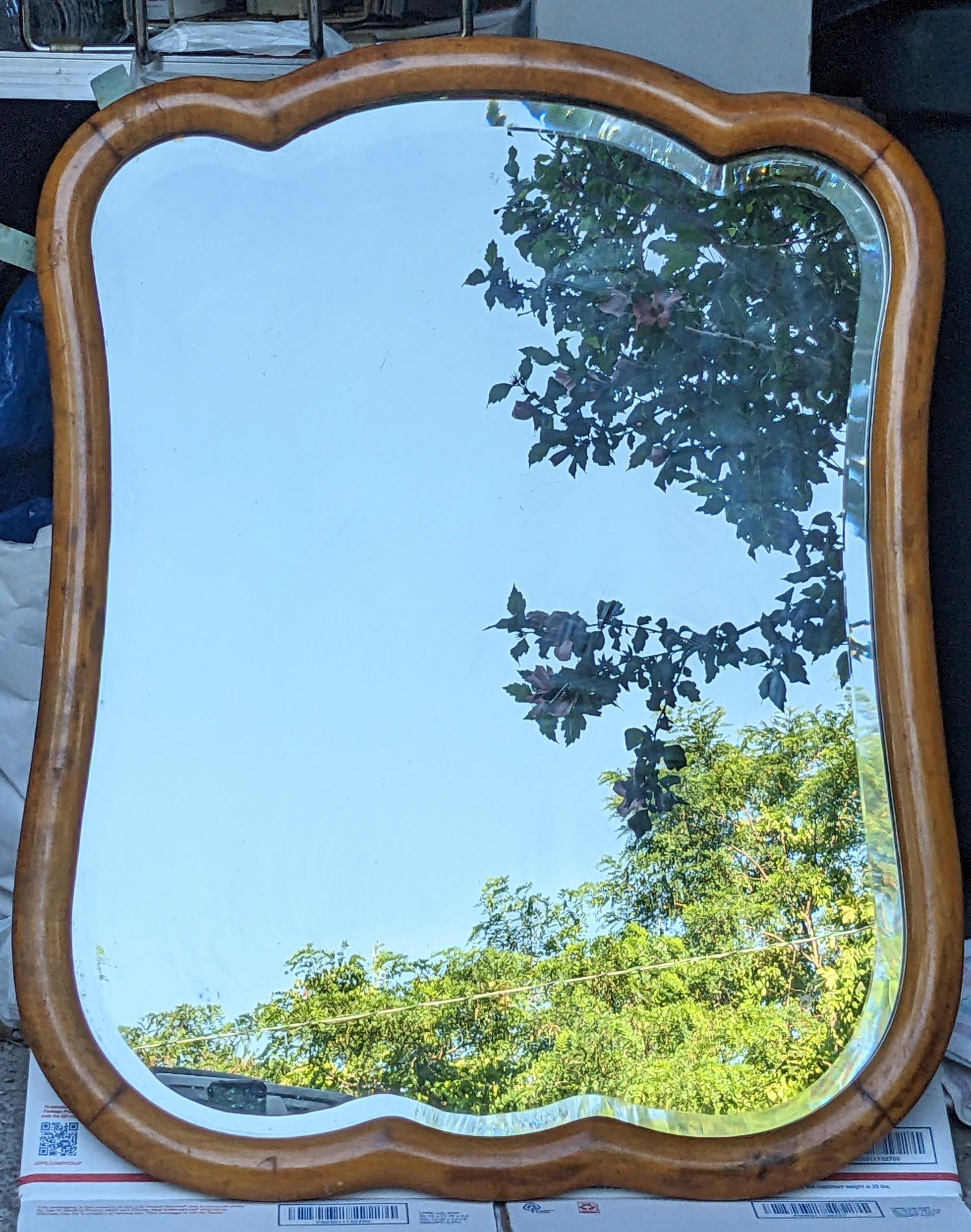Elegant Lobed Wood Mirror with bevel edged mirror from the 1930's. Nice honey toned wood possible maple. This was originally mounted on a piece of furniture like a chest of drawers as there is a small hole on each side for a swivel. Elegant shape.