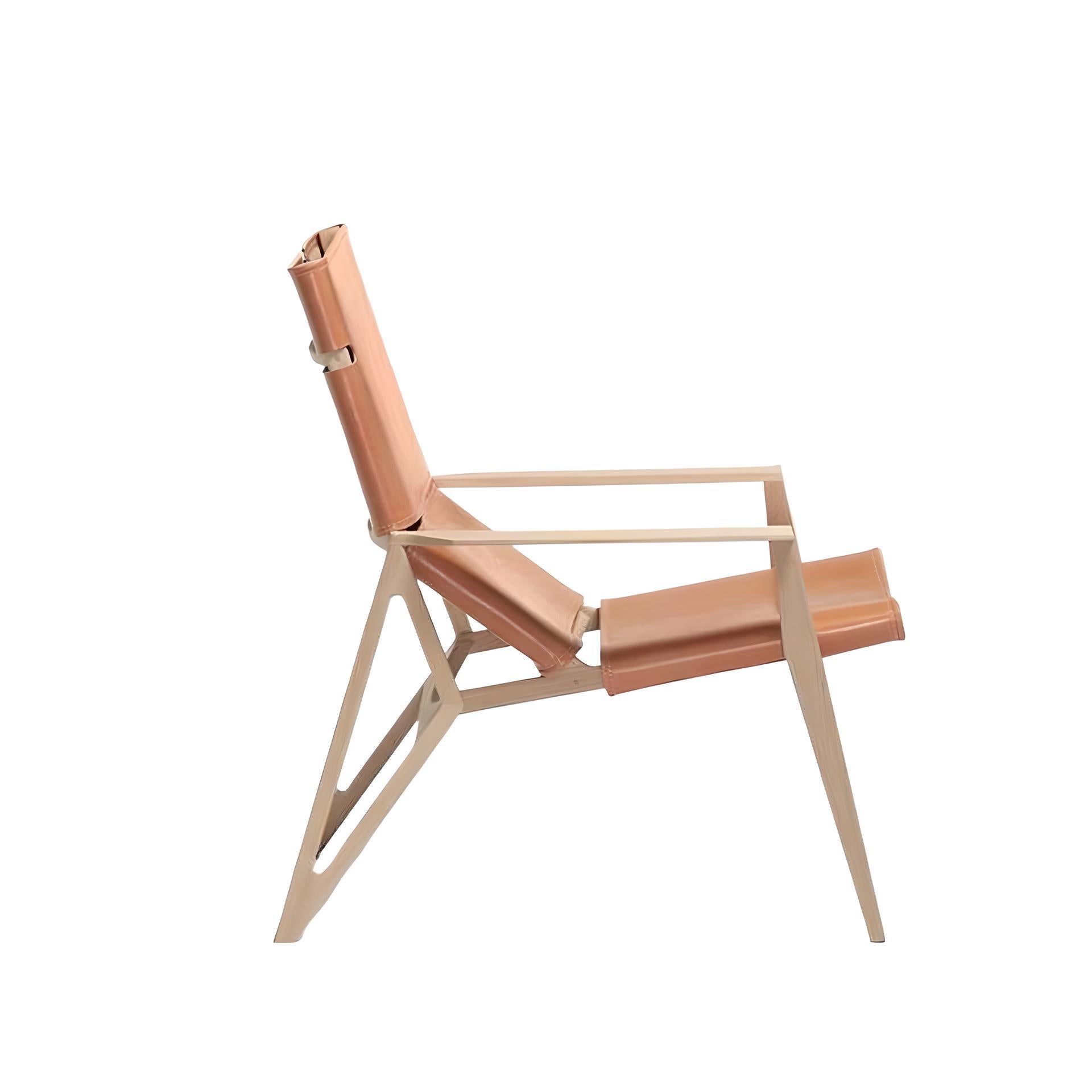 This luxurious lounge chair features a sturdy beech wood frame, providing a durable and reliable foundation. The handcrafted upholstery features a unique braided system using premium grain leather or waterproof premium suede leather, offering a