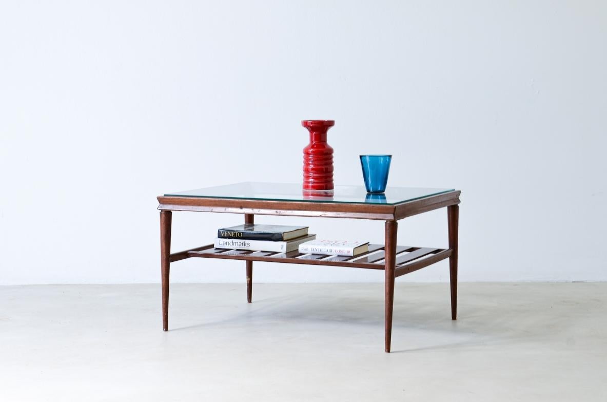 Elegant low table in polished wood with ground glass top and slatted shelf.

Italian manufacture, around 1950.

85x70xh45.