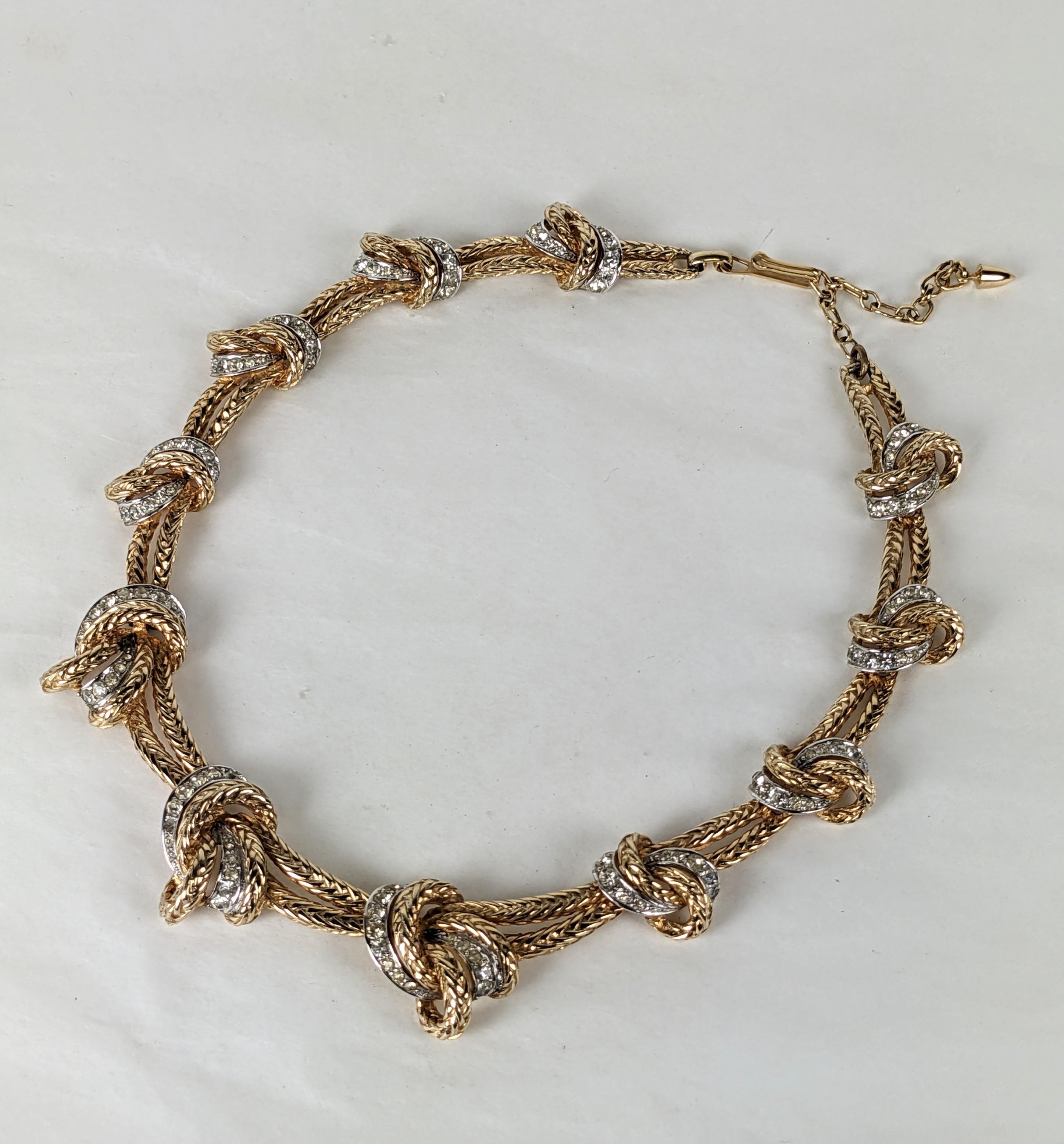 Marcel Boucher Elegant Gold and Pave Knot Necklace from the 1950's. Graduated knot motifs in braided gilt metal with pave accents. Adjustable length. Fits 15