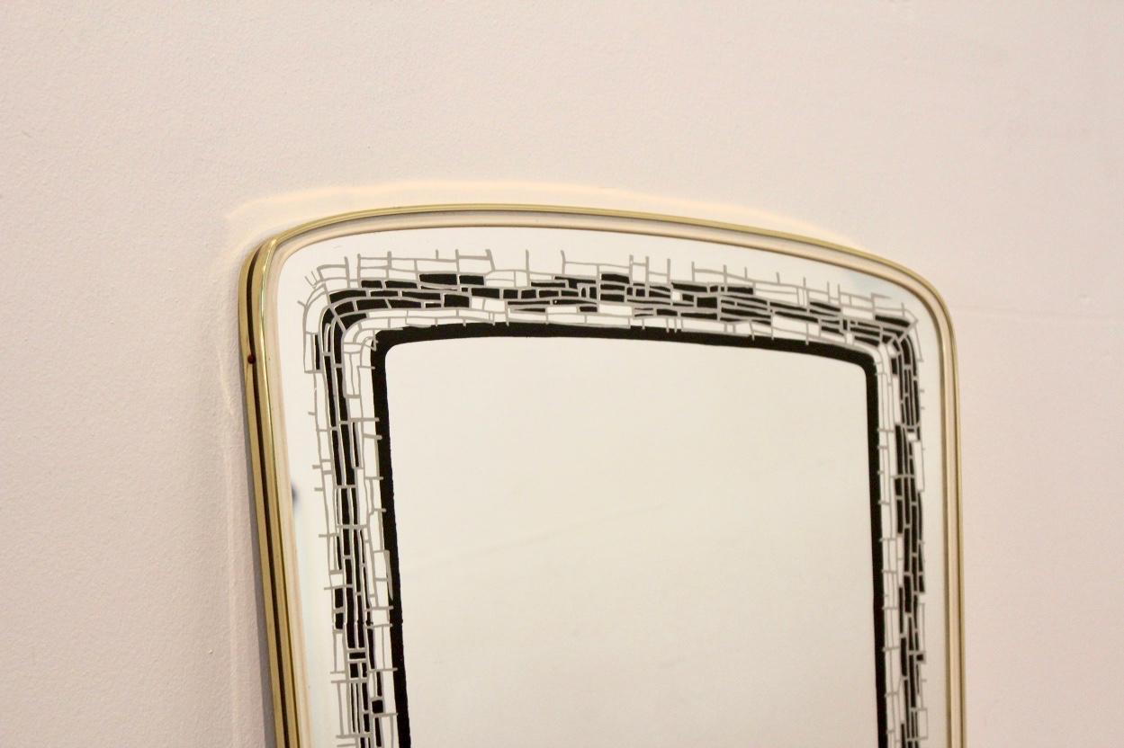 Beautiful brass framed mirror made in France. Very elegant with a beautiful and unique black mosaic lining in the glass and in very good condition.