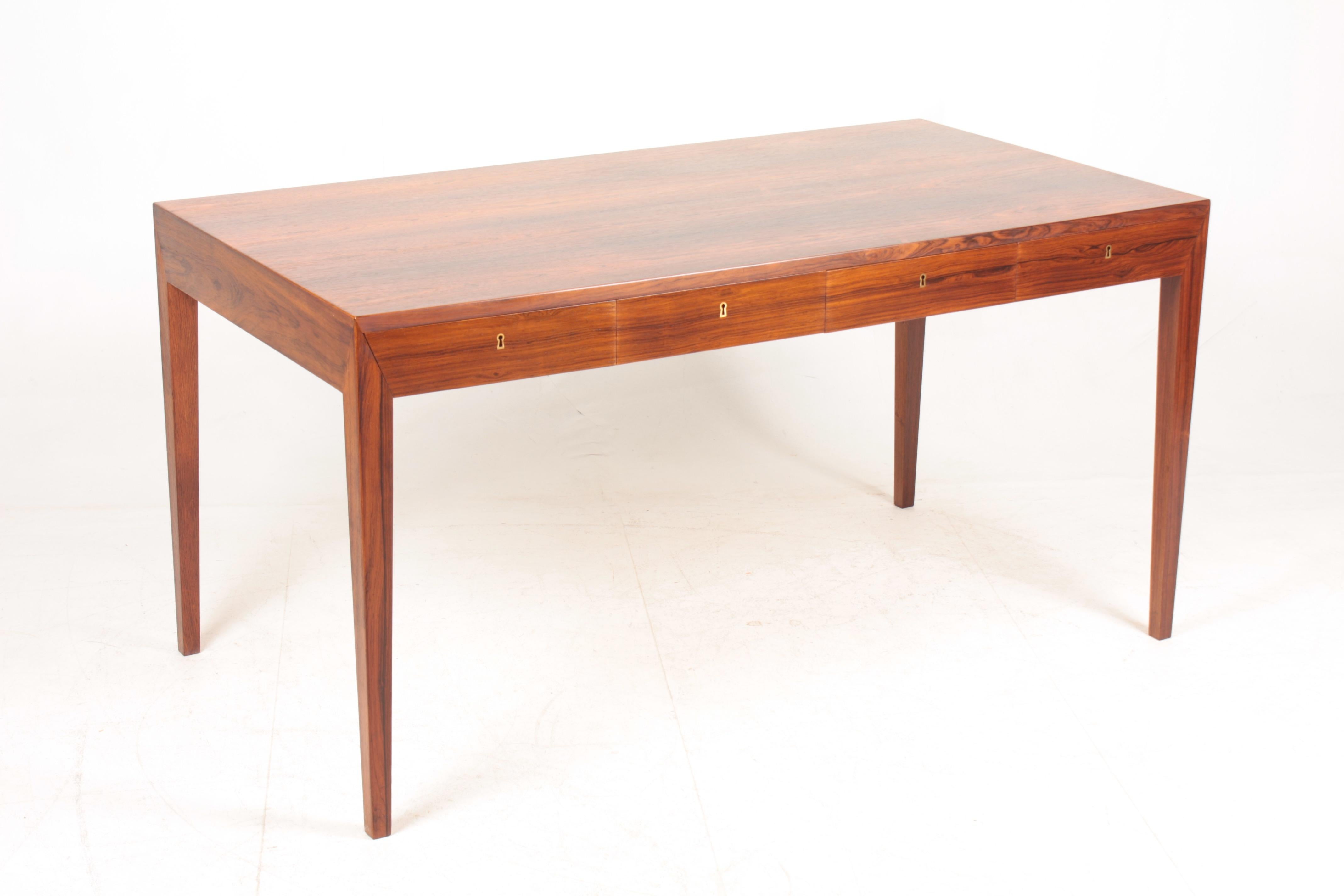 Elegant freestanding Danish design rosewood desk with four drawers designed by Severin Hansen Jr. for Haslev Furniture in the late 1950s. Made in Denmark, great original condition.