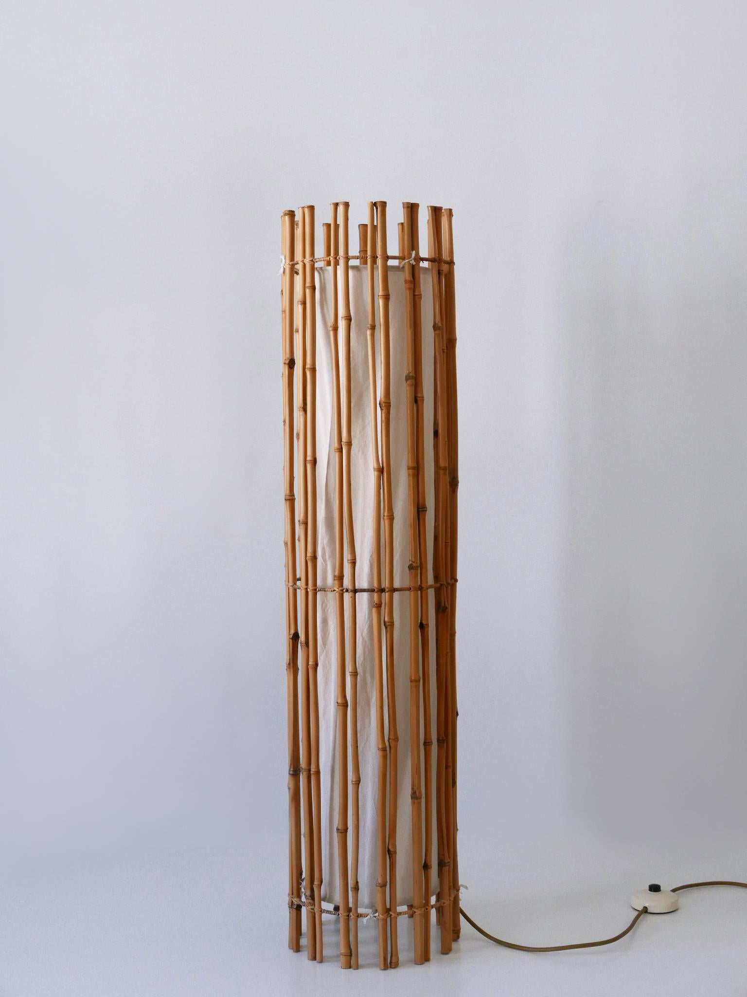 Extremely rare, elegant and highly decorative cylindrical bamboo floor lamp. Designed and manufactured probably by Louis Sognot, France, 1960s.

Executed in bamboo, cane, metal and cotton fabric, the floor lamp needs 1 x E27 / E26 Edison screw fit