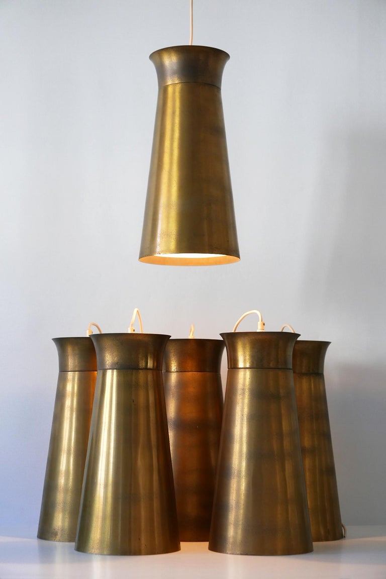 Elegant Mid-Century Modern brass pendant lamps or hanging lights. Designed and manufactured in Germany, 1950s. Six identical lamps available!

Executed in brass sheet, each lamp comes with 1 x E27 Edison screw fit bulb holder, is wired and in