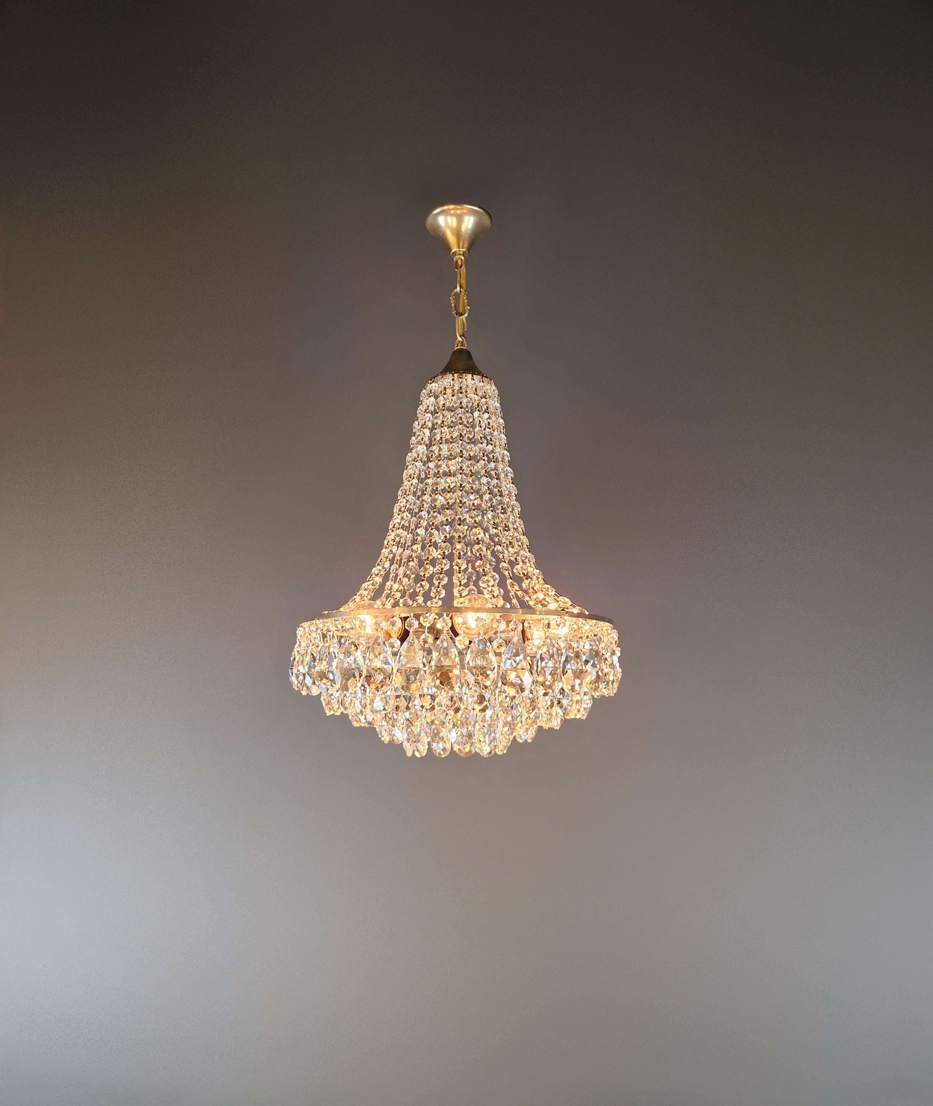 For sale is an elegant silver chandelier from the Mid-Century Modern era, manufactured in Germany around 1950. This piece combines classic elegance with timeless modernity, making it a perfect addition to stylish living spaces or representative