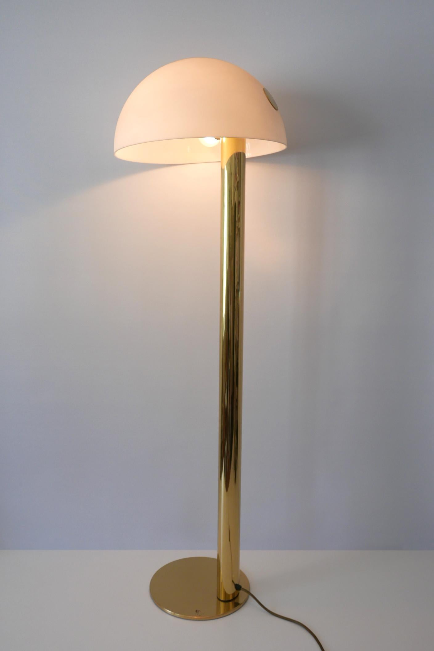 Rare and elegant Mid-Century Modern floor lamp. Designed and manufactured probably by Florian Schulz, 1970s, Germany.

Executed in brass and plastic, the lamp needs 2 x E27 Edison screw fit bulbs, is wired, and in working condition. It runs both on