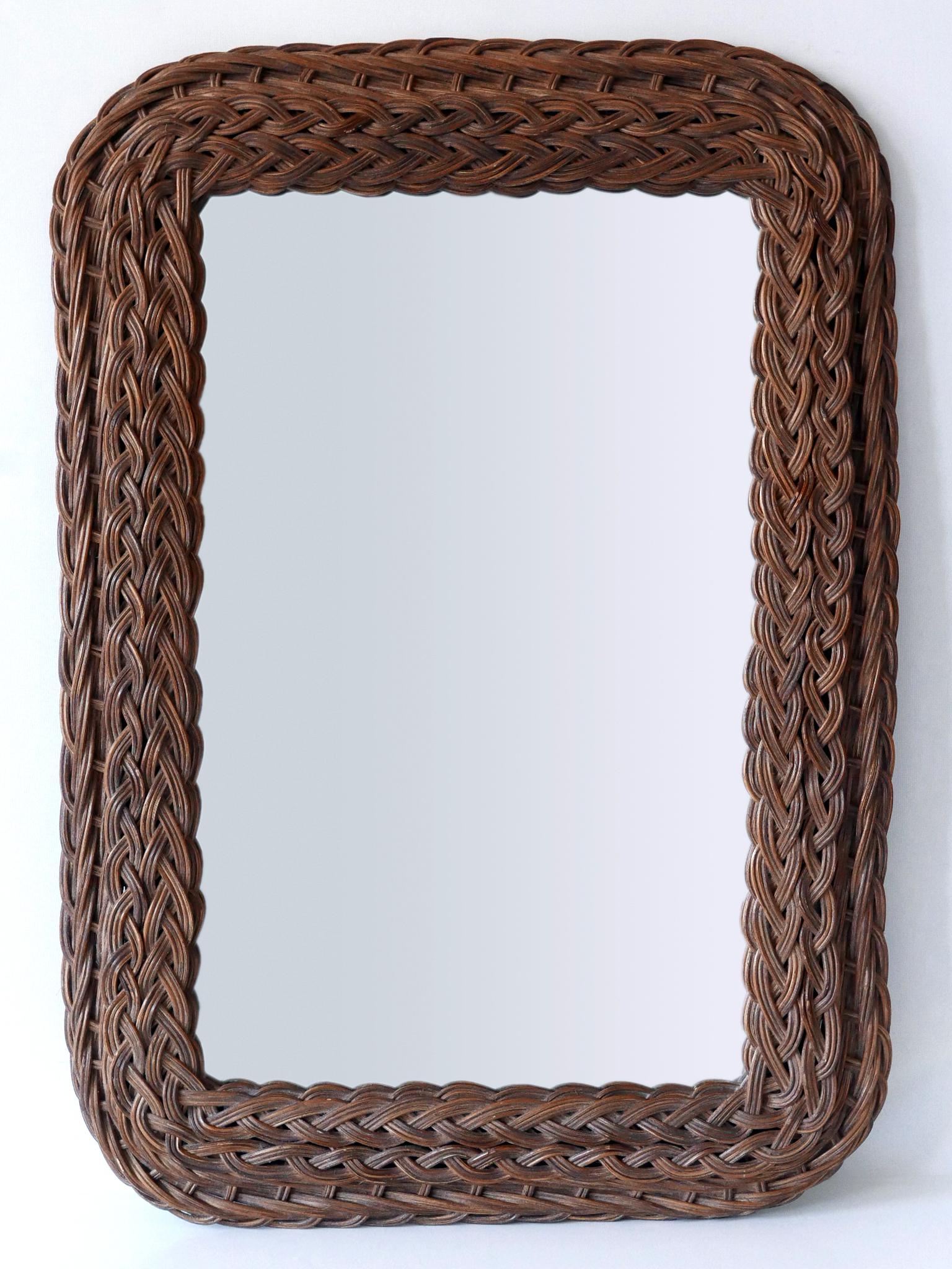Highly decorative and elegant Mid-Century Modern rectangular wall mirror. Manufactured probably in Italy, 1960s.

Executed in rattan, bamboo and mirrored glass.

Condition:
Good original vintage condition. Wear consistent with use and age.