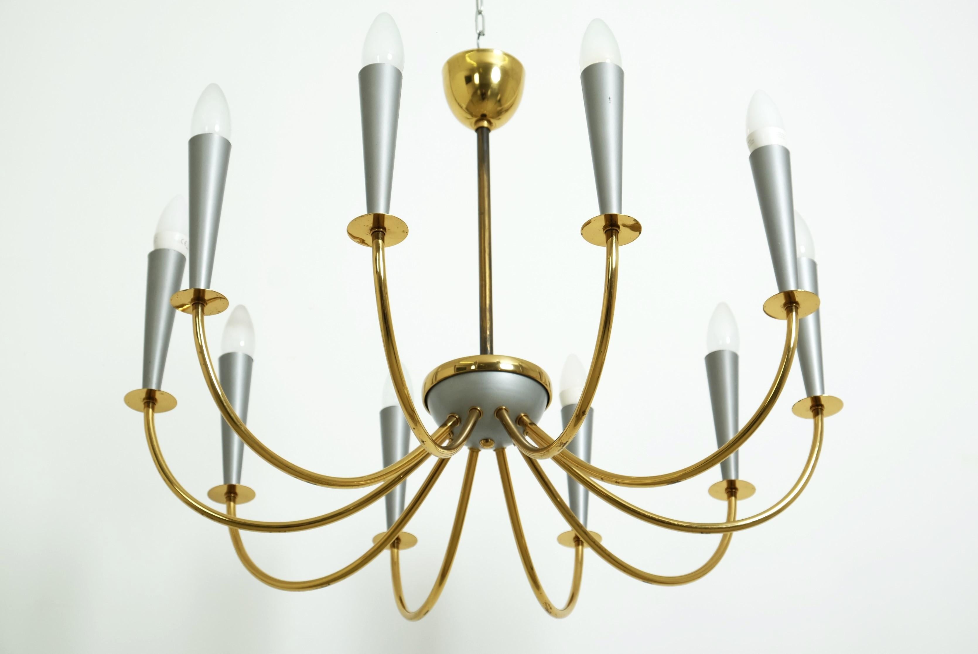 This large 10-armed Sputnik chandelier, which was manufactured in Germany in the 1950s, is a real eye-catcher. 

It has ten brass arms, each ending in silver-colored metal cones fitted with an E14 light bulb socket.

Good original vintage condition