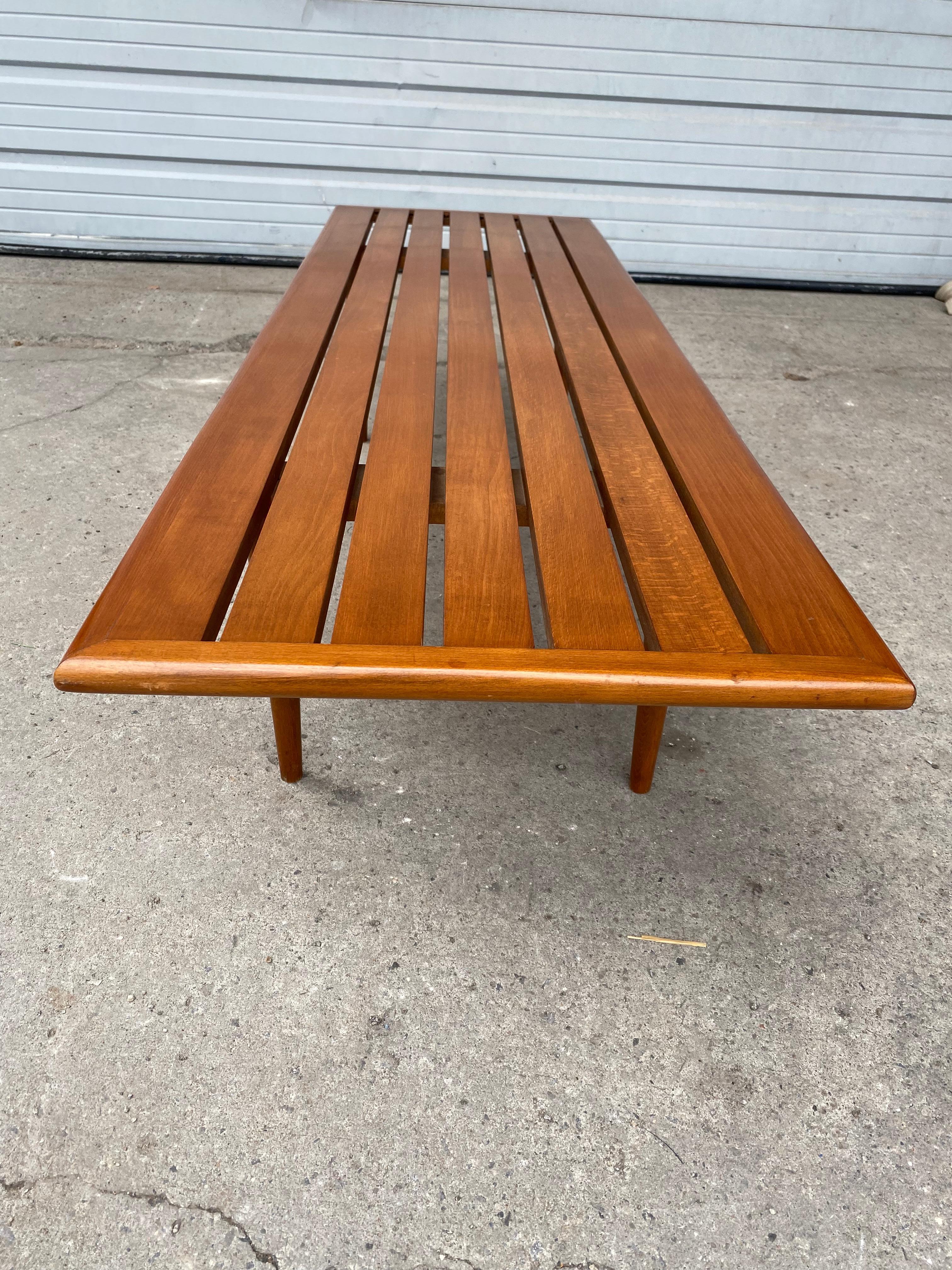 Elegant mid century modernist coffee table/ slat bench..,, simple, sleek design, wonderful quality and construction. Retains original finish, patina, fit seamlessly into any modern, contemporary environment. Hand delivery avail to new York City or