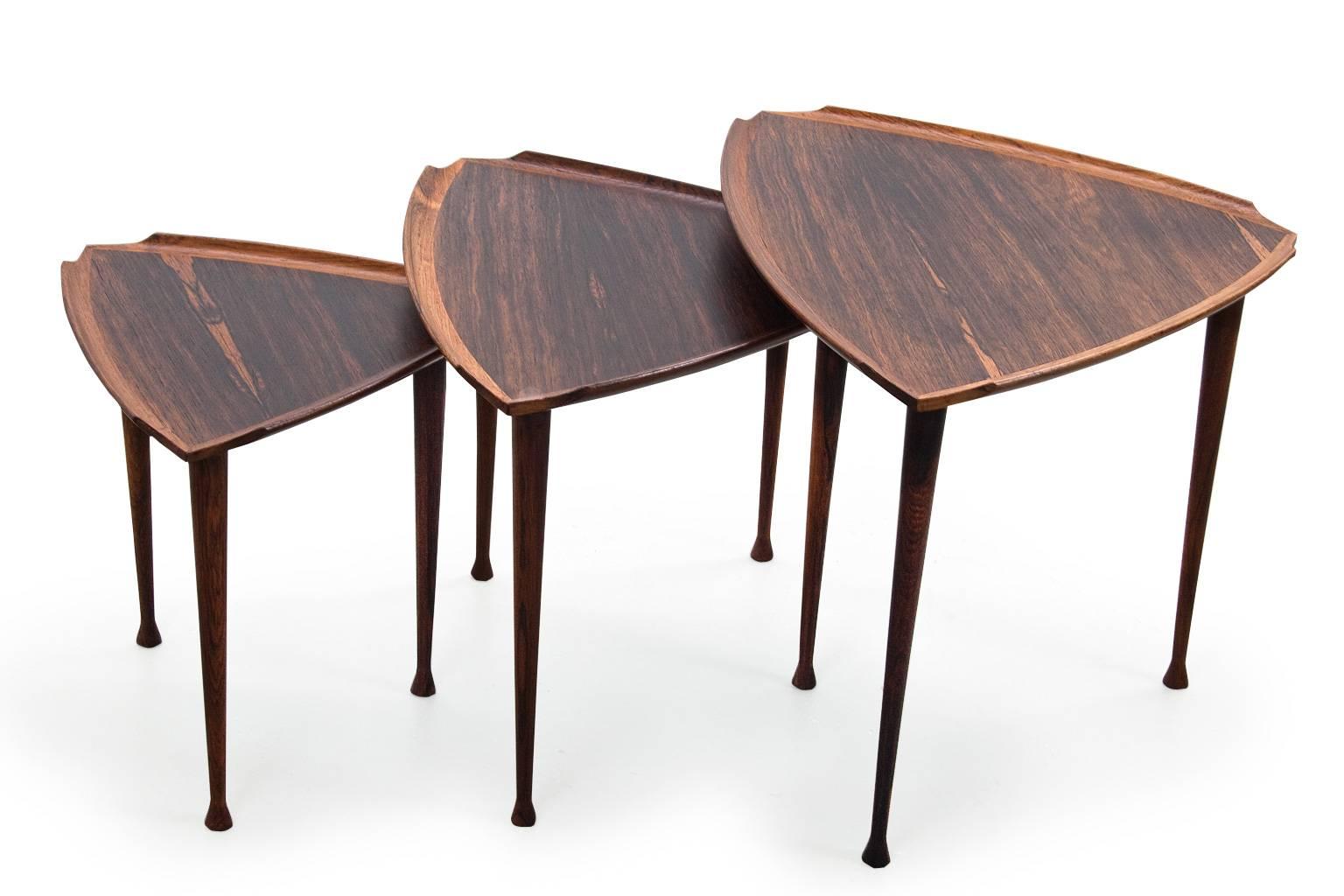 Elegant and very refined set of three Mid-Century Modern nesting tables, often referred to as 'guitar pic' because of the shape of the table tops. The items originated from Denmark, 1960s, most likely made by Poul Jensen or Harald Quistgaard. There