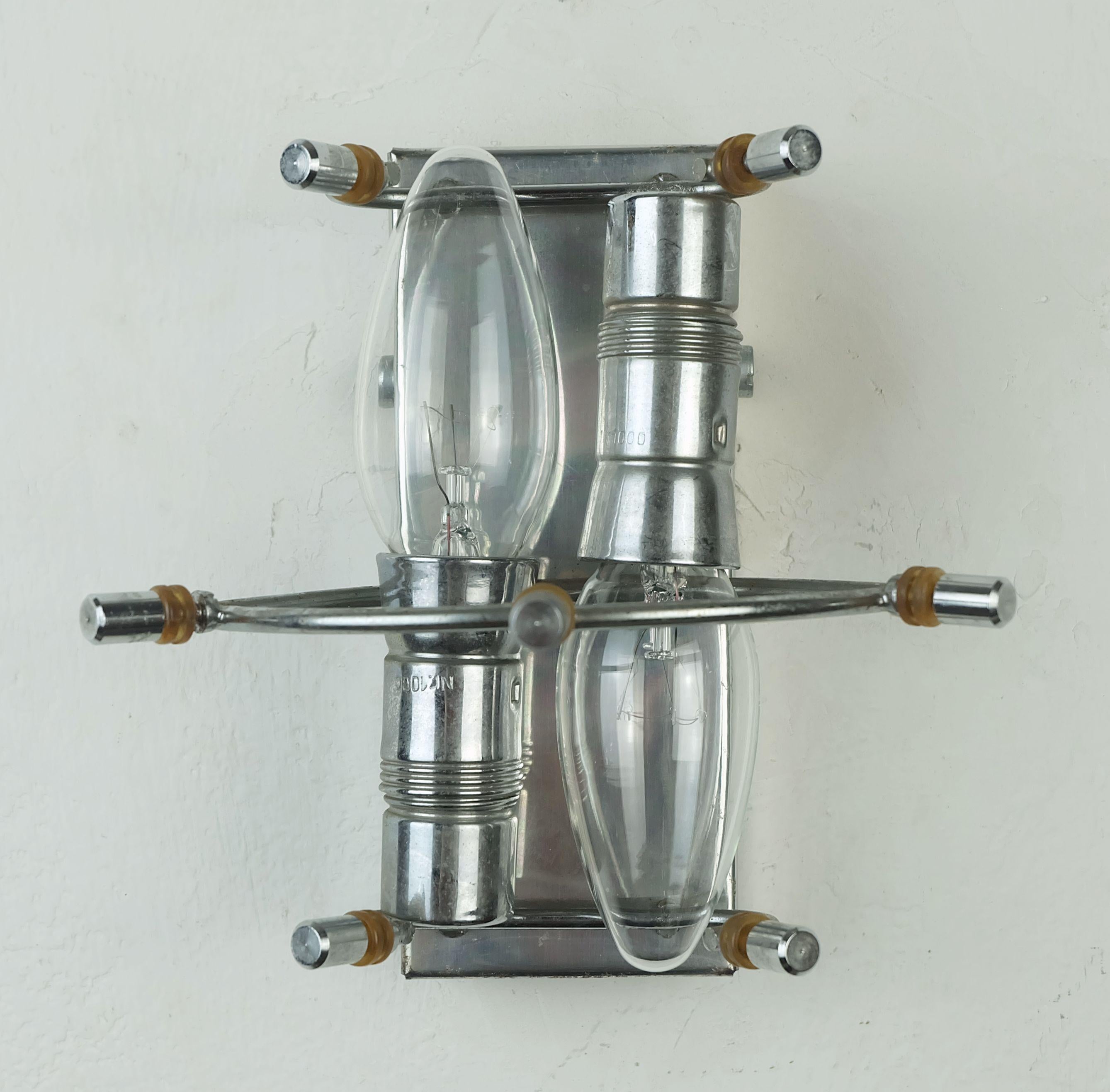 A very beautiful and elegant small wall lamp by Kinkeldey from the 1960s. Chrome-plated metal, seven hexagonal, elongated glass prisms. The shade consists of five glass prisms each. For two E14 light bulbs. For direct wall connection without a