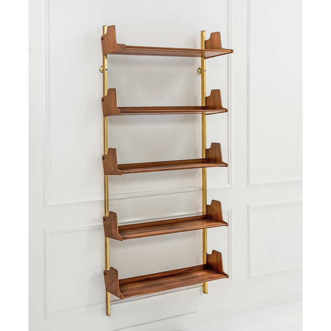 Elegant shelving unit Model E60 designed by Osvaldo Borsani for Tecno. The shelves can be moved up and down as required. The bottom shelf is slightly deeper than the others which visually anchors the unit to the ground. The shelves are in teak. This
