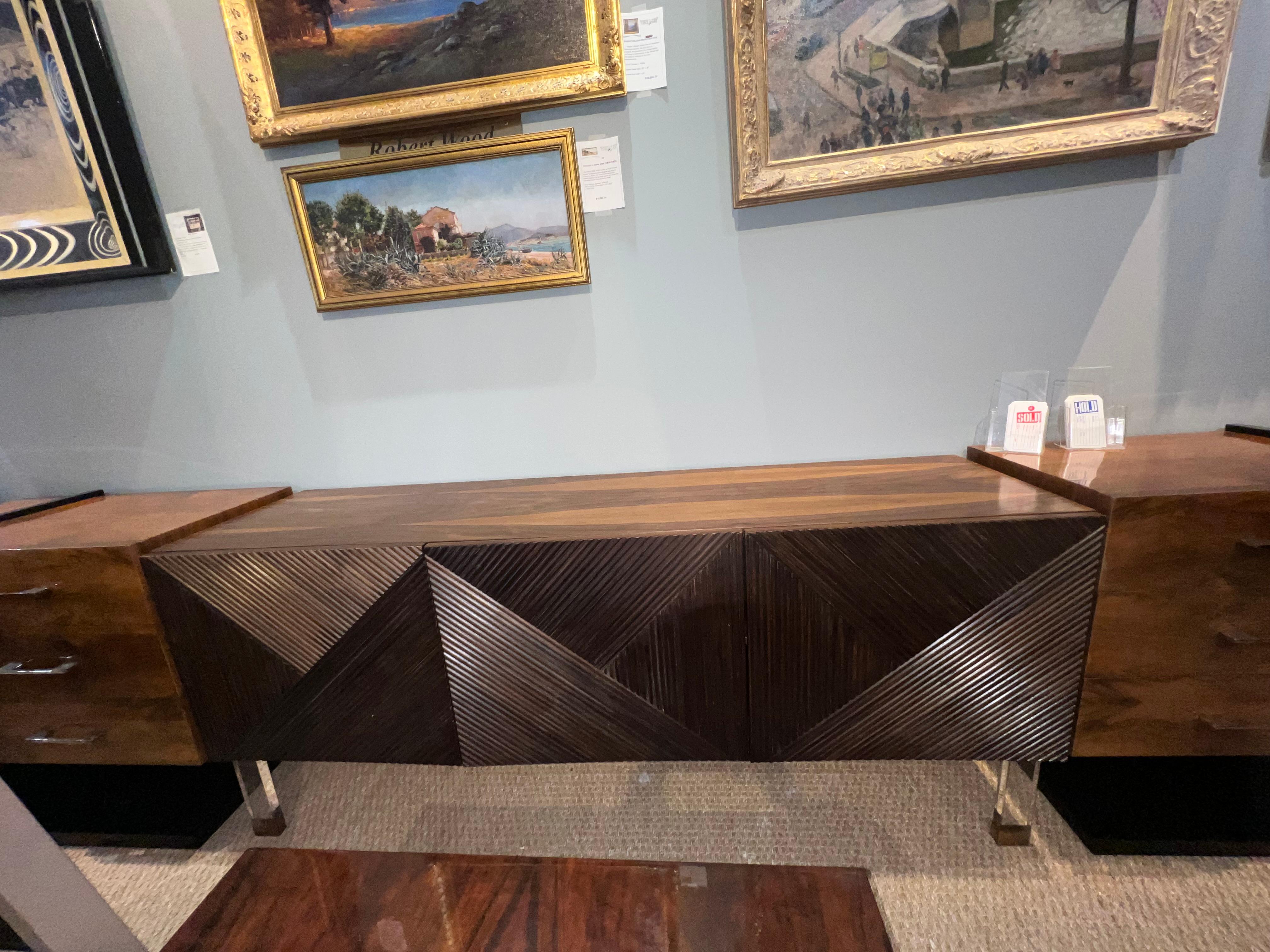 Elegant Mid-century sideboard made out of walnut wood. It has 3 doors with lots of storage space. Sideboard is elevated by 4 legs made out of bakelite with brass tips. 

Condition is good. restored
Italy, c. 1970s
71