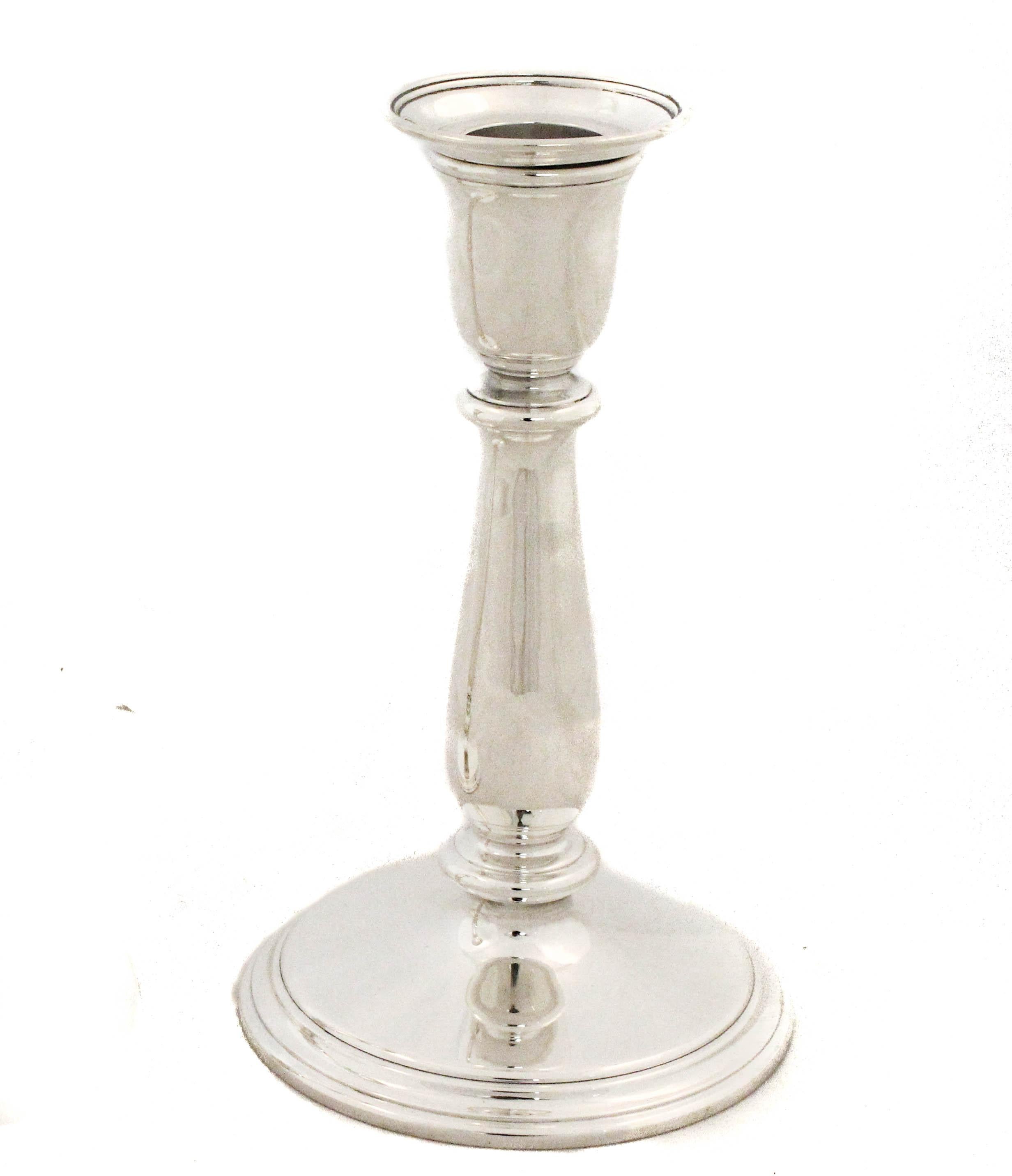 A refined pair of Tiffany & Company candlesticks, crafted in sterling silver during the Mid-Century era. Each measures 7 inches tall and is notably not weighted, showcasing the quality and solid craftsmanship for which Tiffany is renowned. The