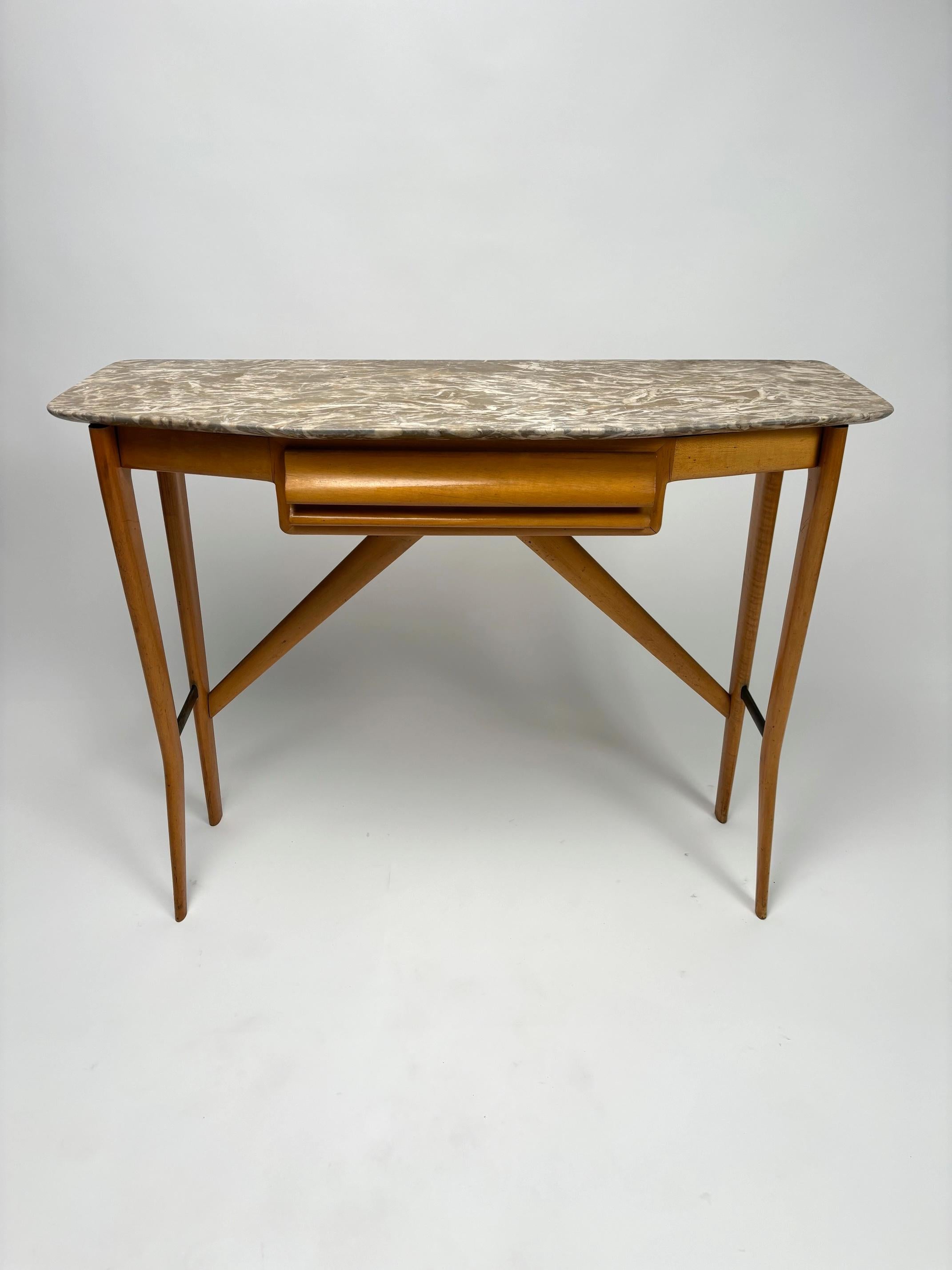 This midcentury Italian console table is the perfect addition to any entrance or hallway.
 The frame is crafted from wood with a natural, warm-toned finish, highlighting the slender, slightly slanted legs, joined by a central crosspiece for added