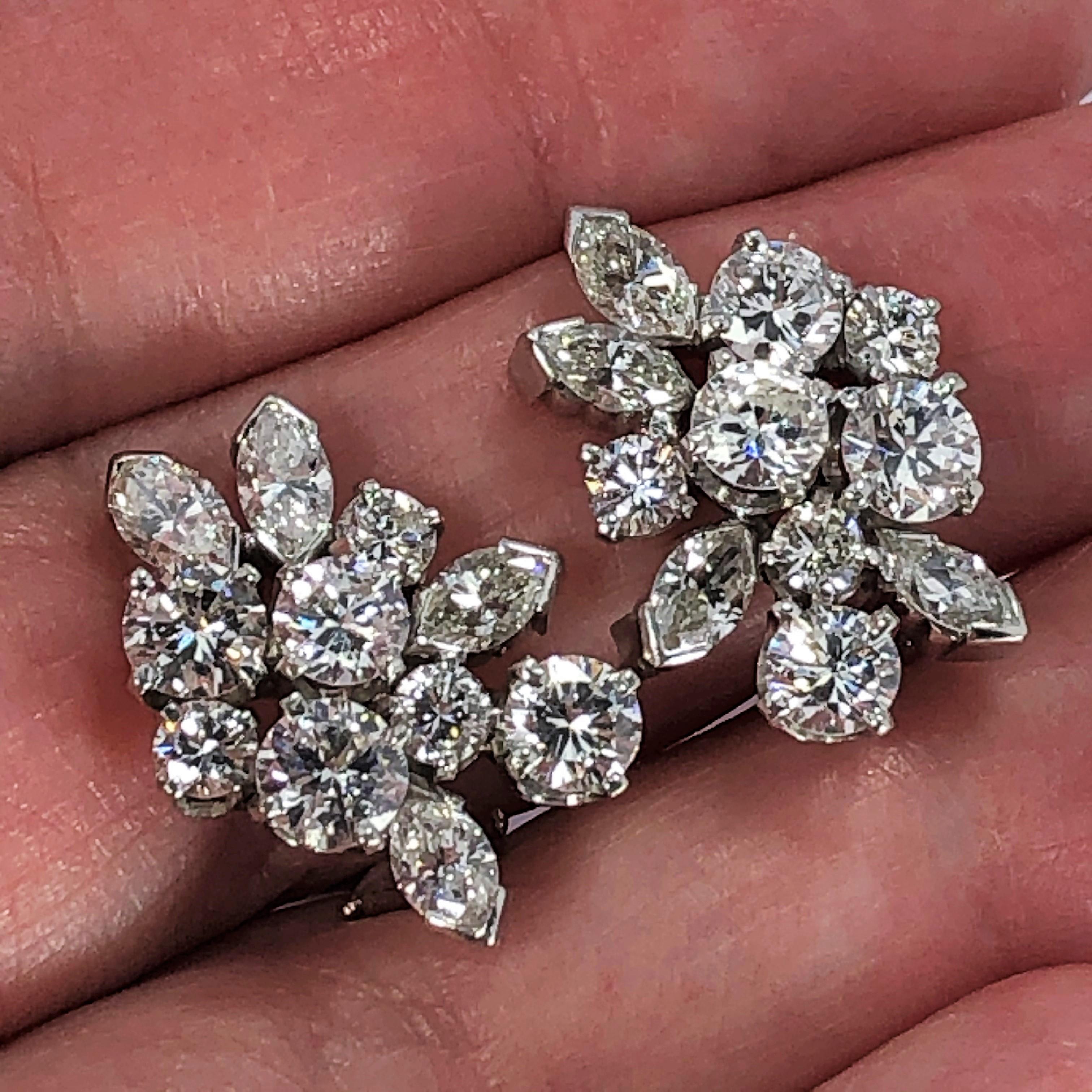 These elegant,  Mid-Century diamond cluster earrings are ideal for the lady who wears 
mid-size earrings. Set in platinum with 14 round brilliant cut diamonds and with 8 
marquise cut diamonds. The total approximate diamond weight is 4.10CT of