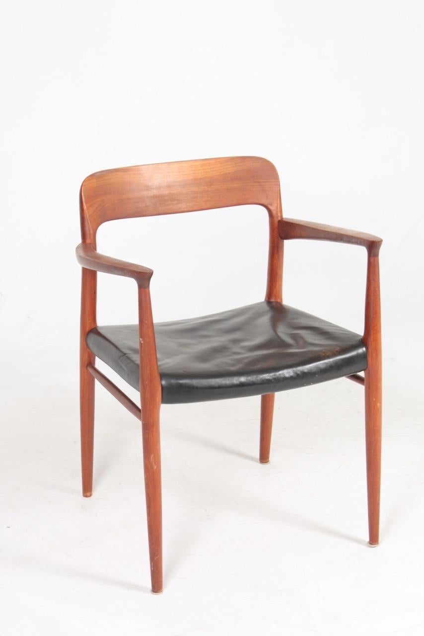 Armchair in teak and seat in patinated leather designed by N.O Moeller. Model NO56. Made by JL Moeller cabinetmakers of Denmark. Great condition.