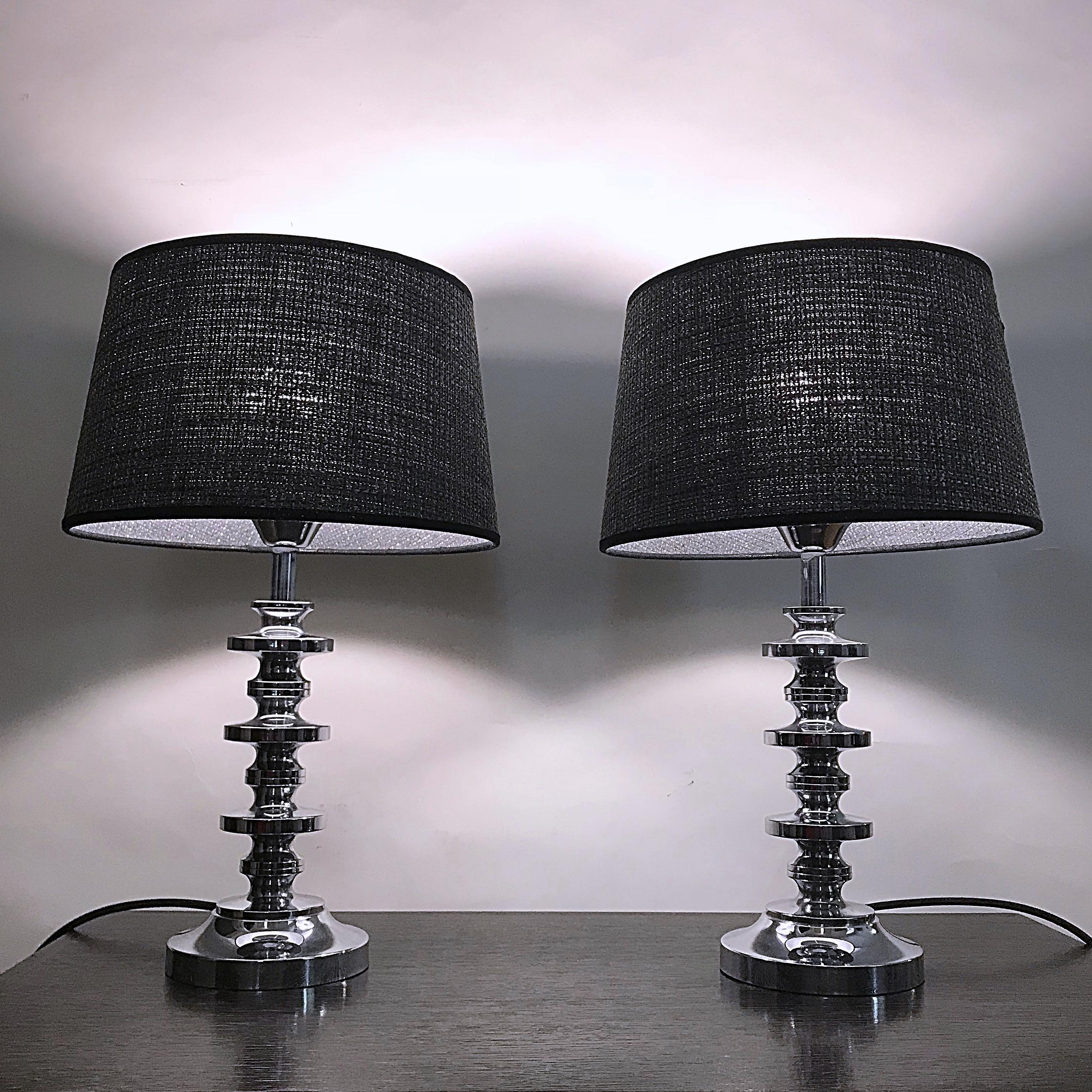 Pair of Italian Mid-Century Modern table lamps attributed to Gaetano Sciolari. The lamps are made of very heavy polished massive steel in high quality. The shades are handmade of Chanel fabric and provide a large-area light. Newly rewired and tested