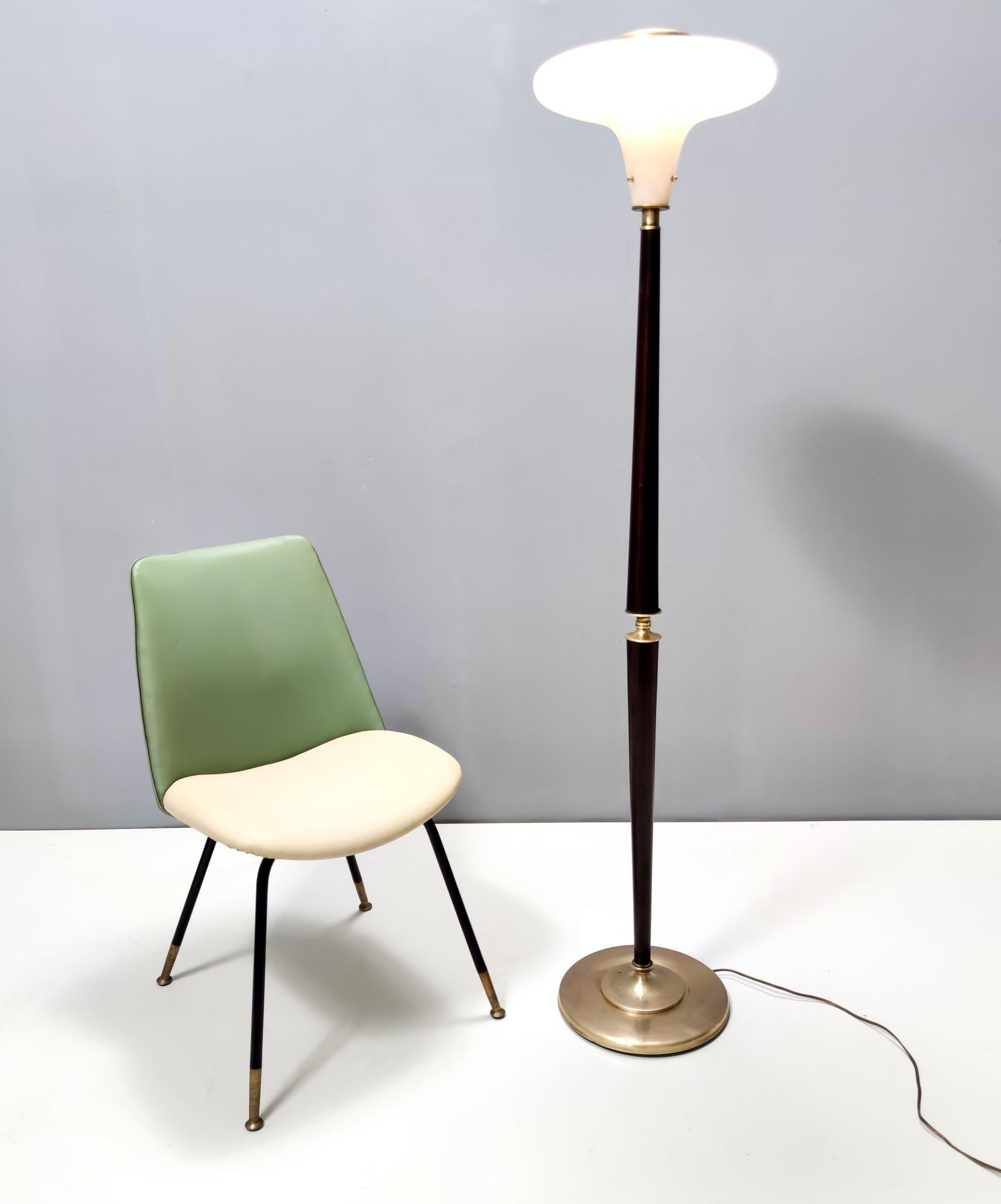 Made in Italy, 1950s. 
This beautiful floor lamp features a wood and brass frame and a glass lampshade. 
It is a vintage piece, therefore it might show slight traces of use, but it can be considered as in very good original condition and ready to