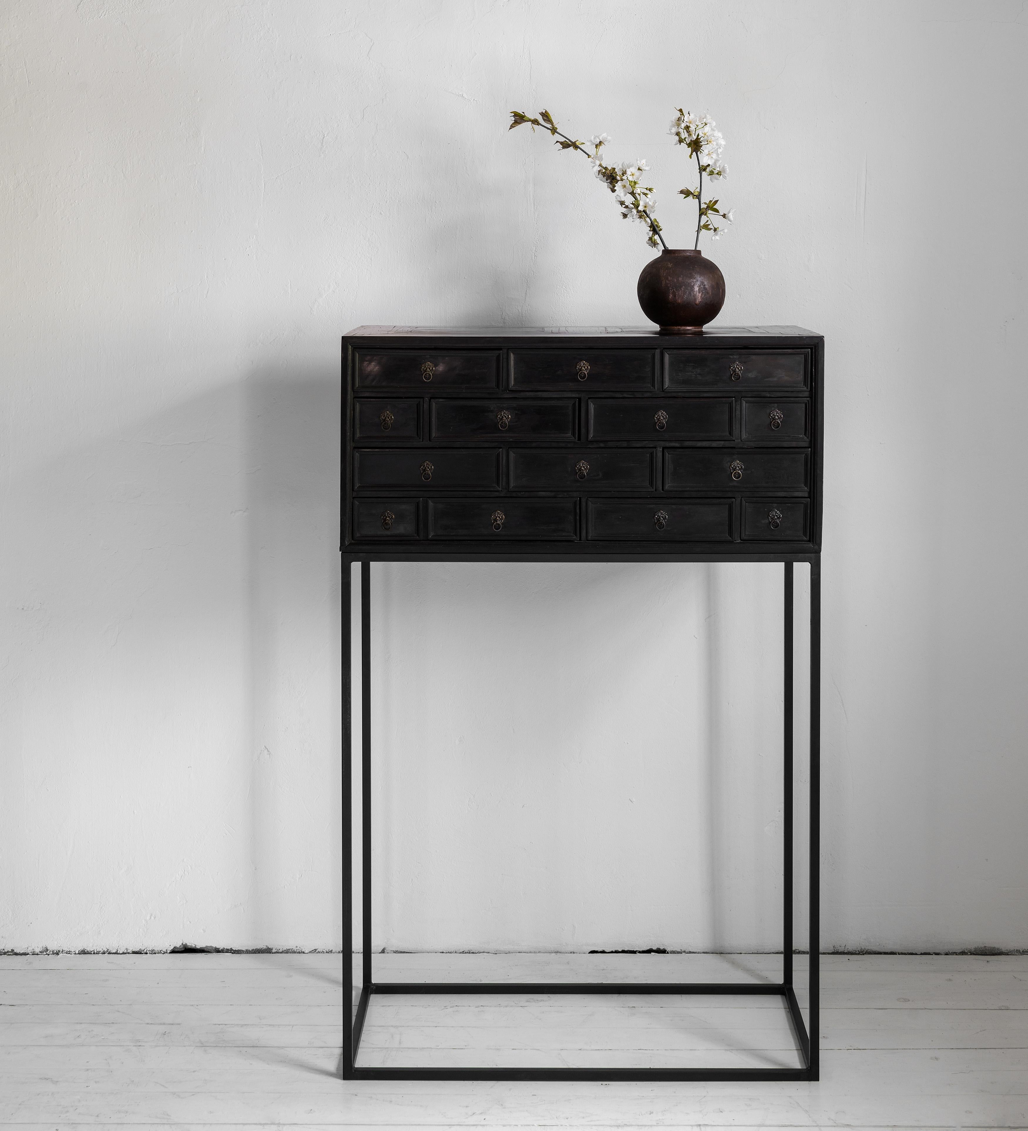 A statement piece that will make an impact in most settings. 
The antique cabinet itself is 36 cm high. It is mounted on a modern hand-forged frame. Which shows a perfect symbiosis of antique and modern elements.


